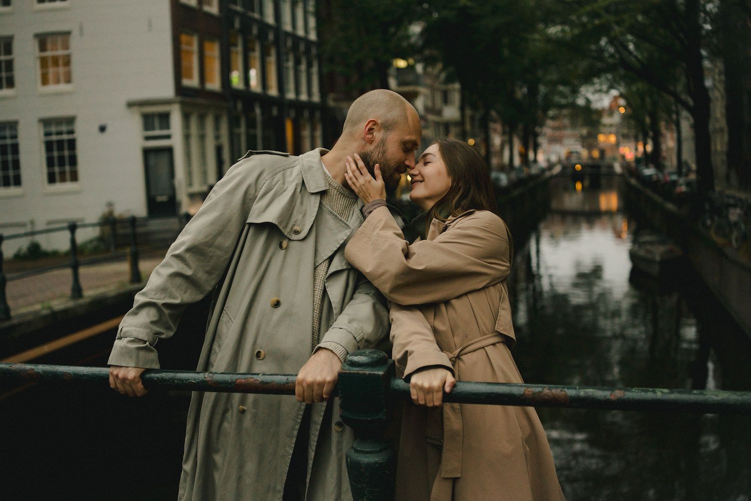 Couple sharing a quiet moment on a bridge beside a canal