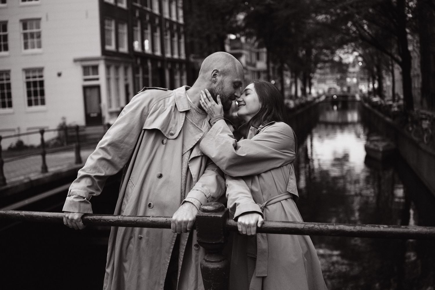 Couple sharing a quiet moment on a bridge beside a canal