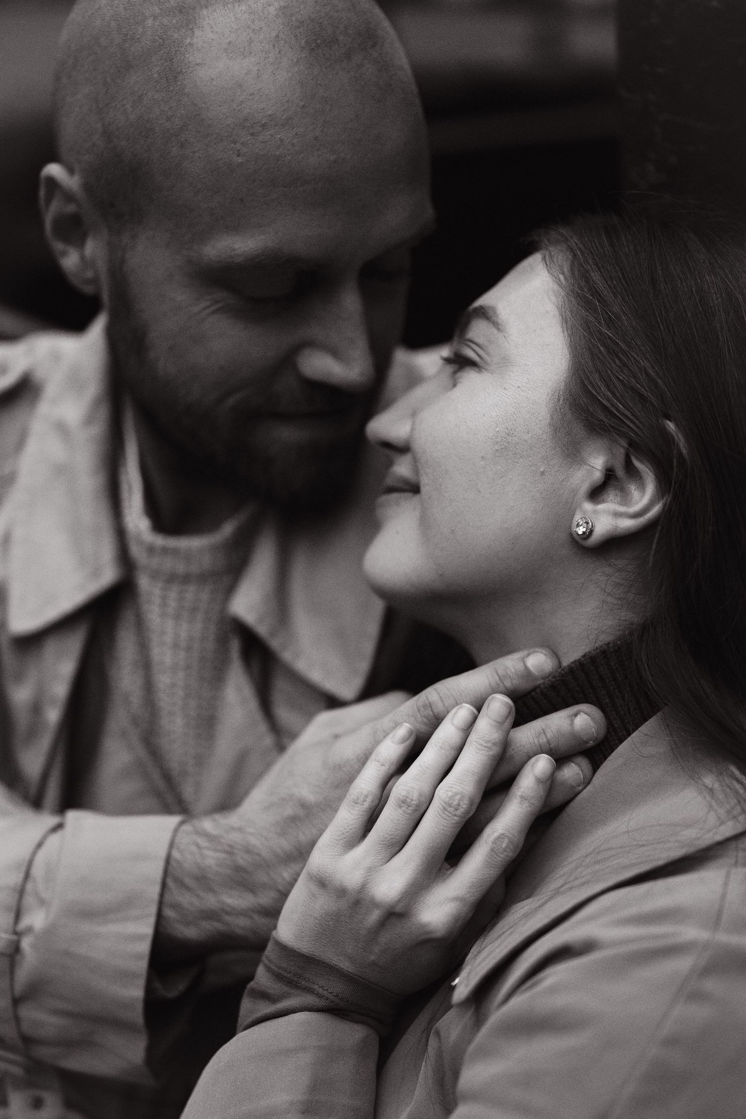 Black and white portrait of a couple sharing a quiet, affectionate moment