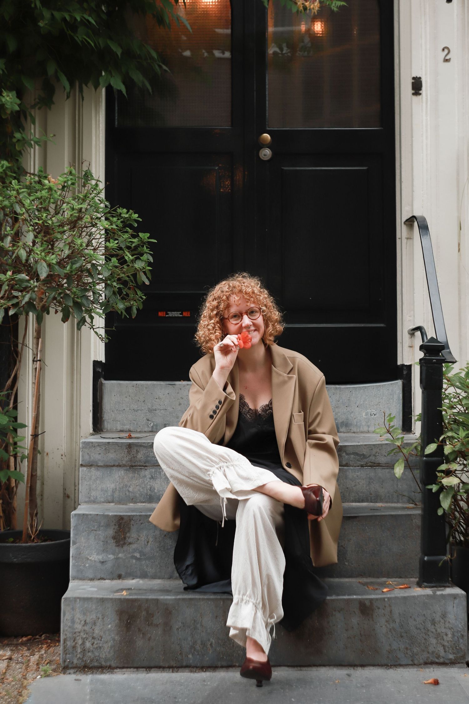 Woman enjoying a quiet moment on the steps outside a cafe