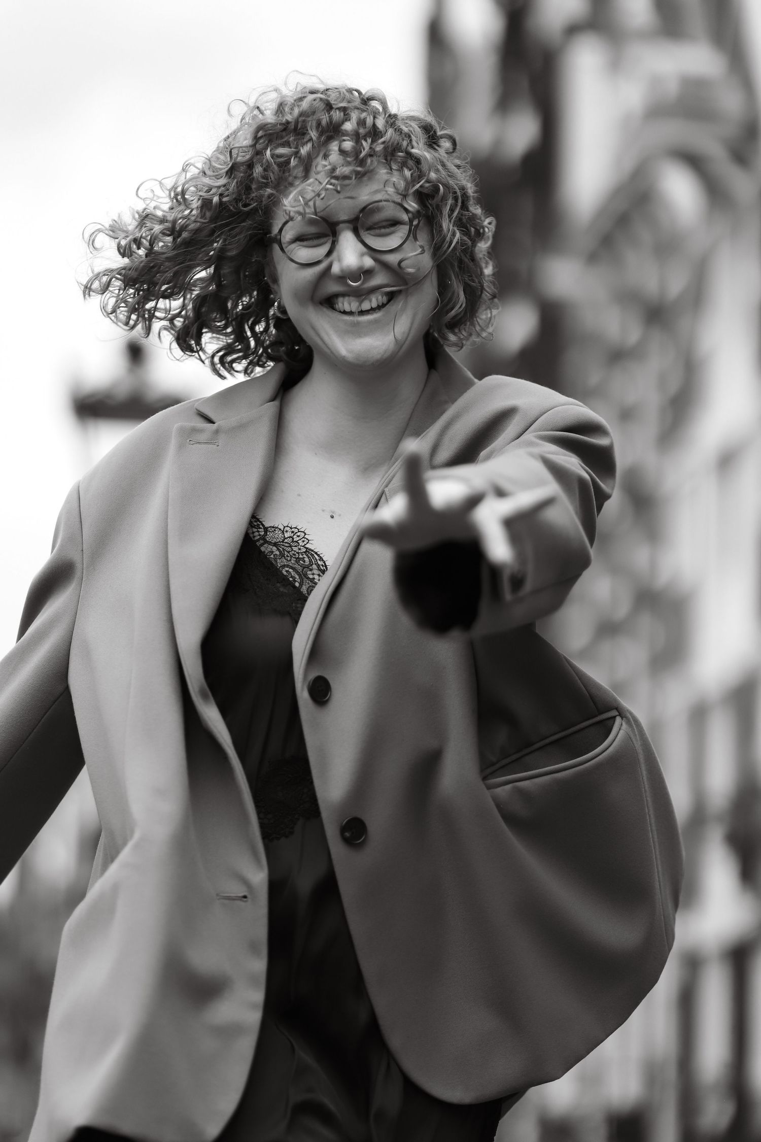 Black and white portrait of a woman reaching towards the camera