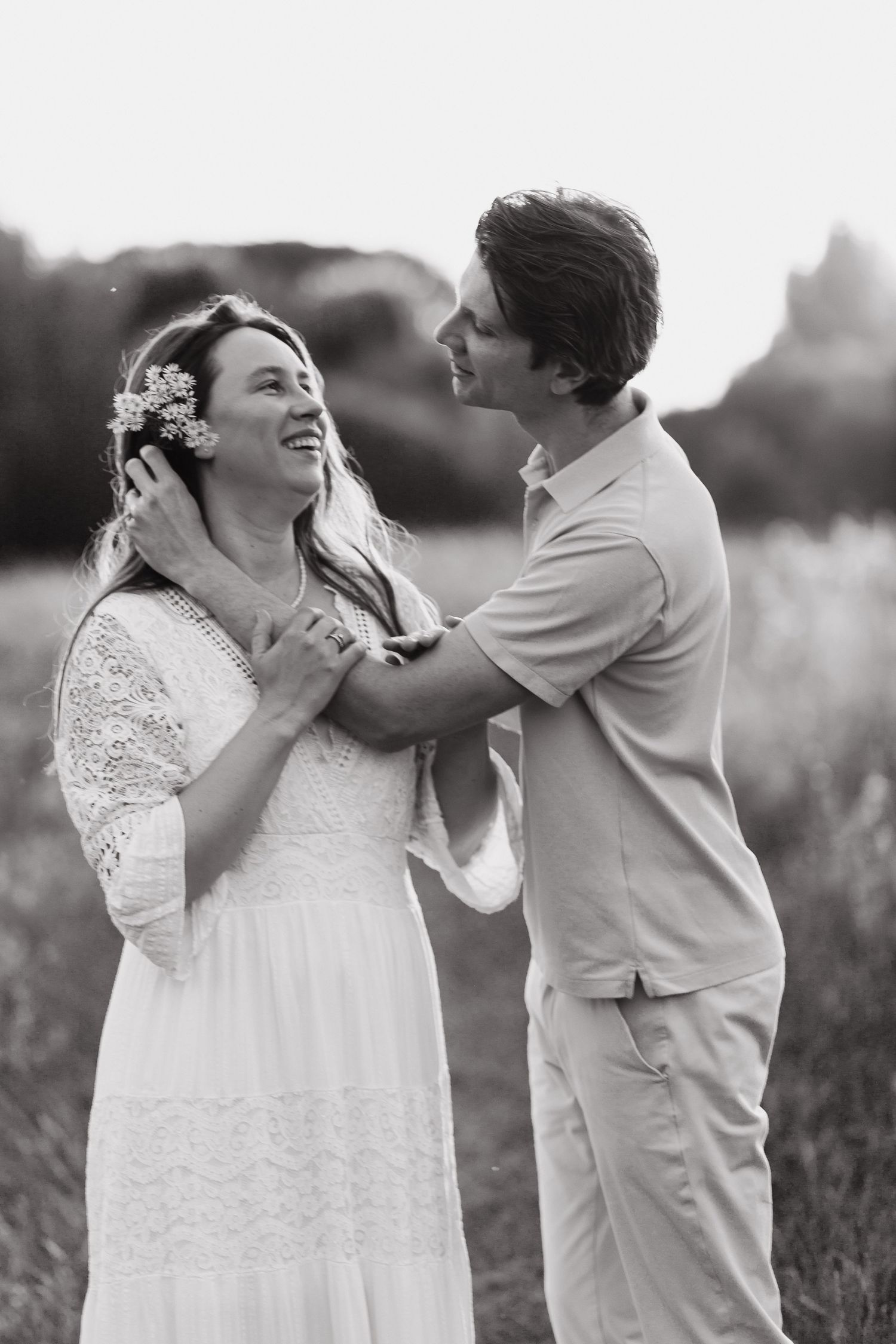 Couple smiling at each other during a relaxed outdoor photoshoot
