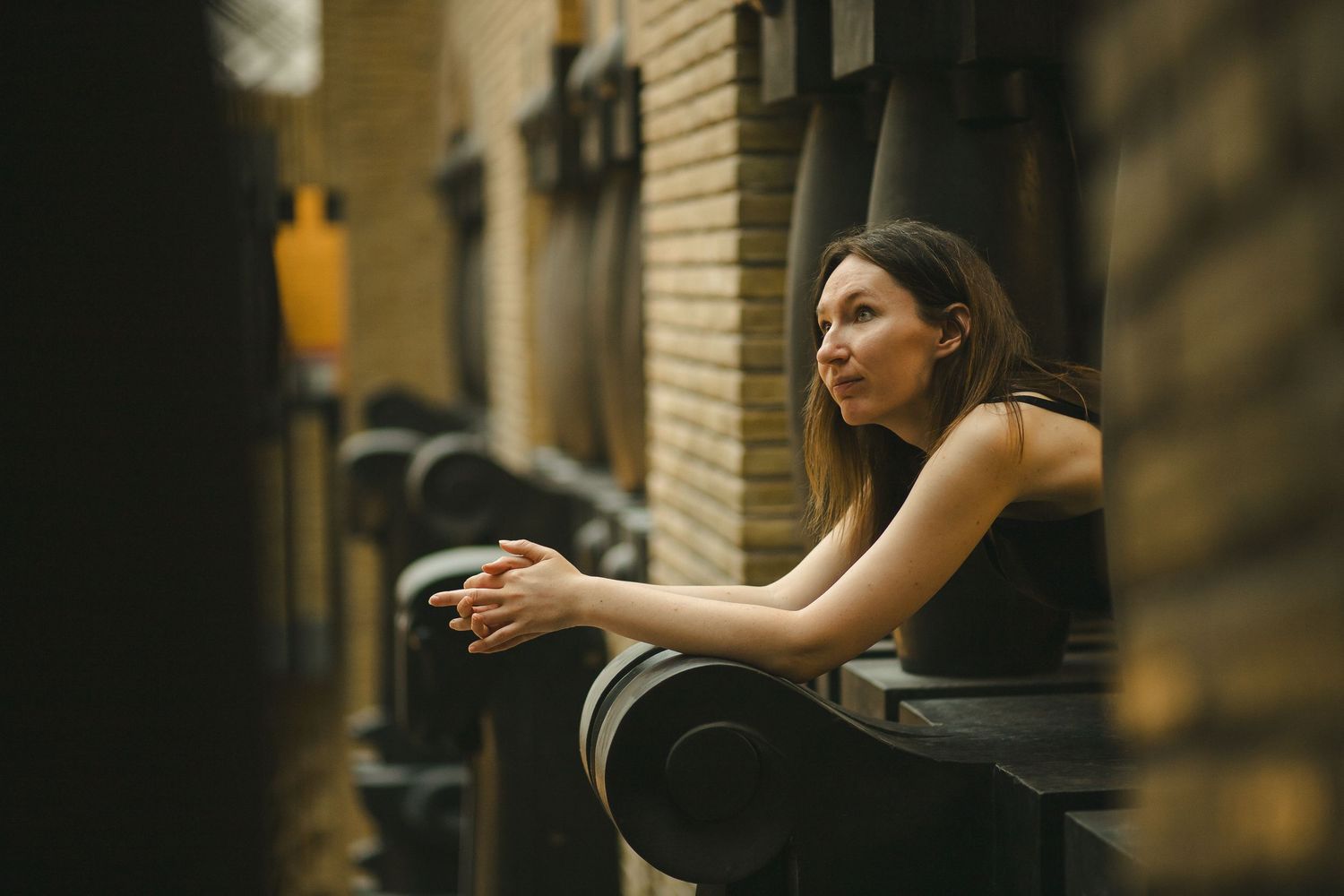Woman leaning on a chair during an indoor portrait session
