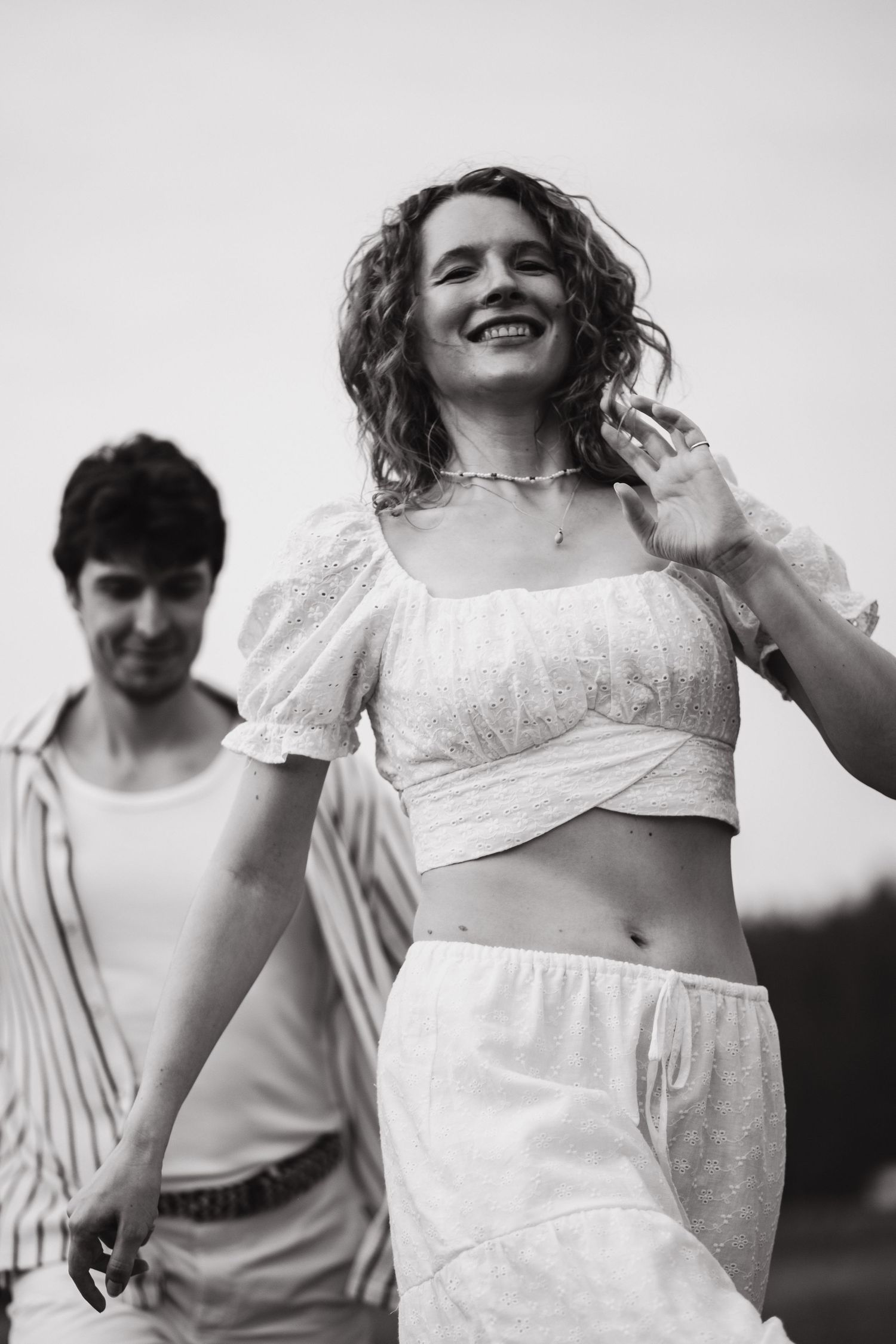 Couple walking together and smiling during an outdoor photoshoot