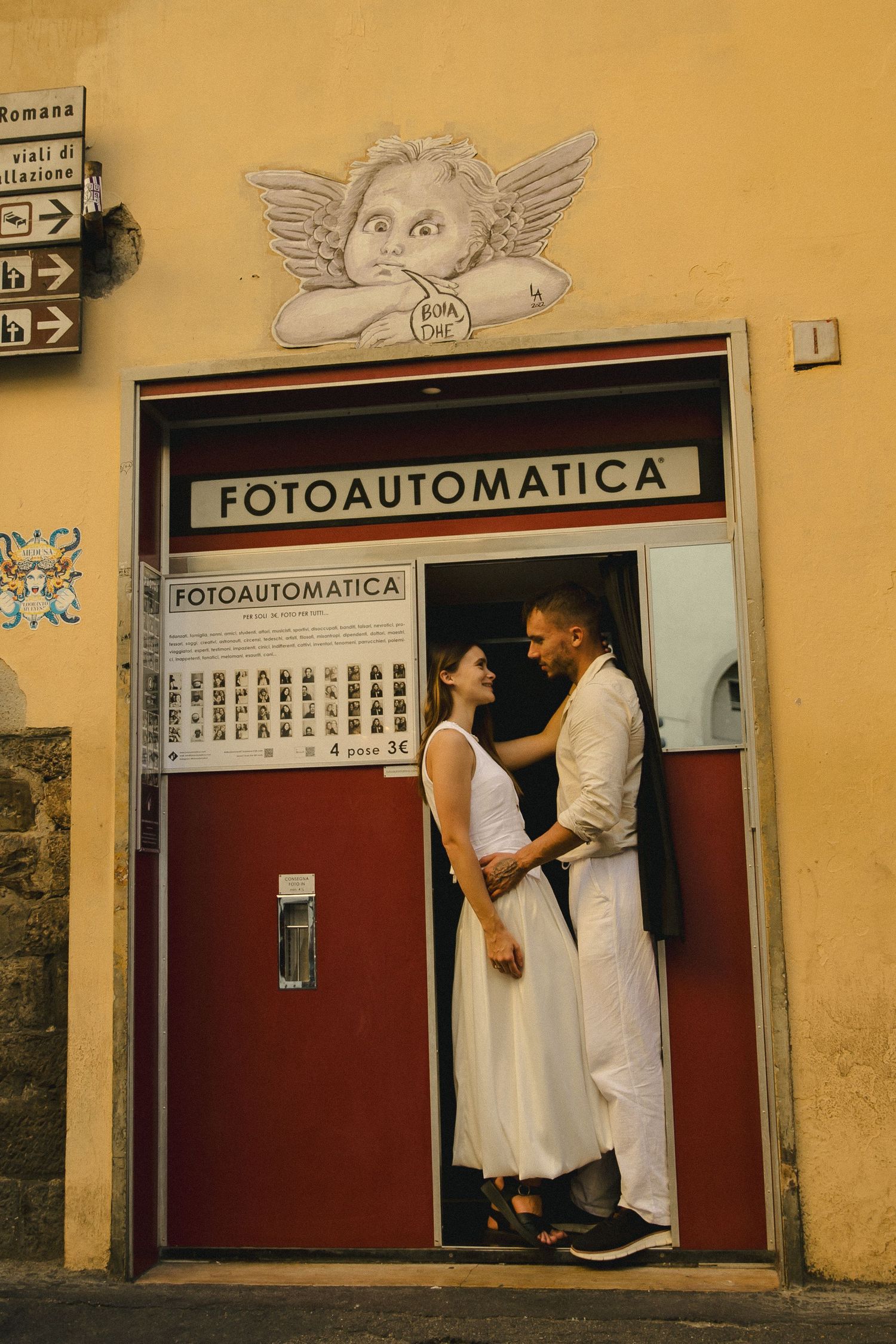 Couple embracing in front of a photo booth