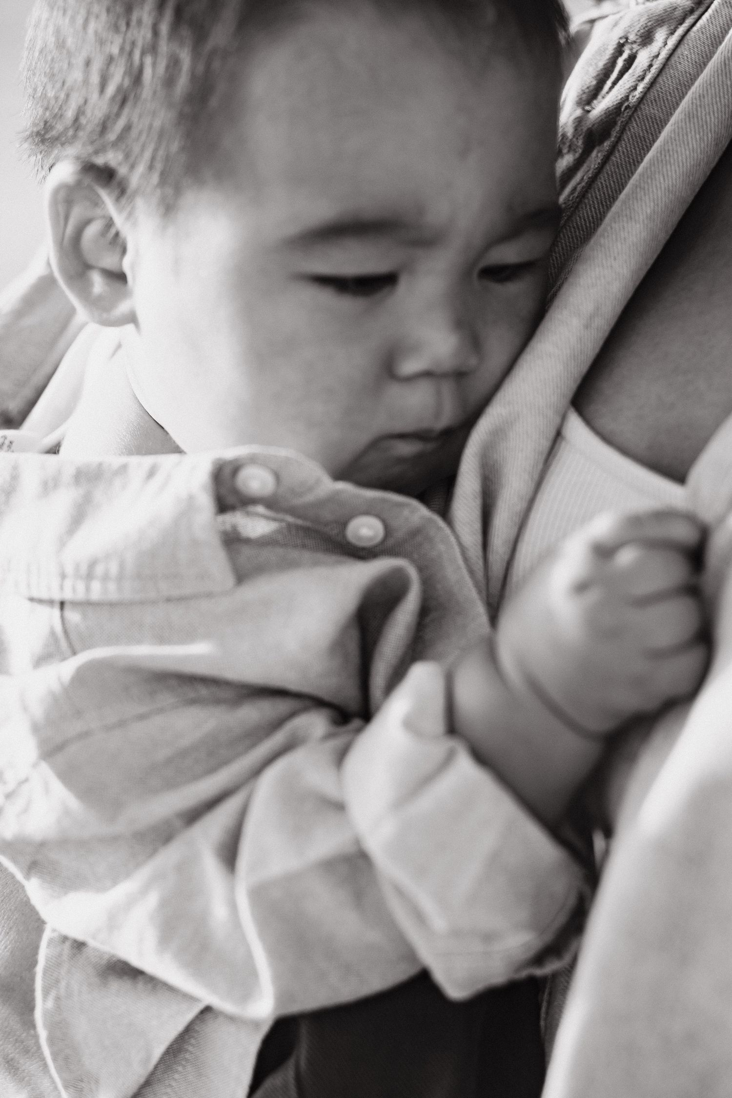 Baby sleeping in a parent’s arms