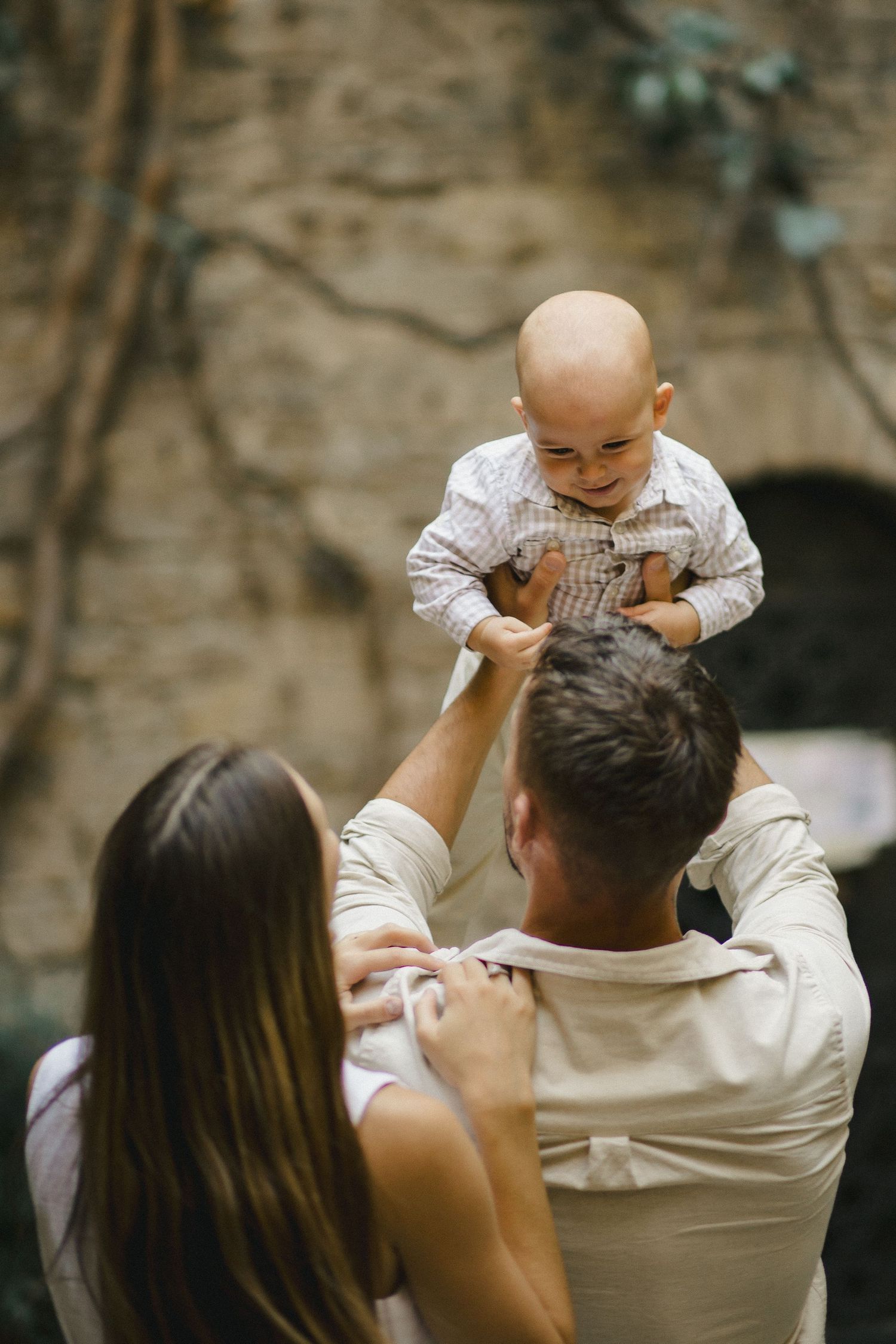 Parents lifting their baby during an outdoor family photoshoot