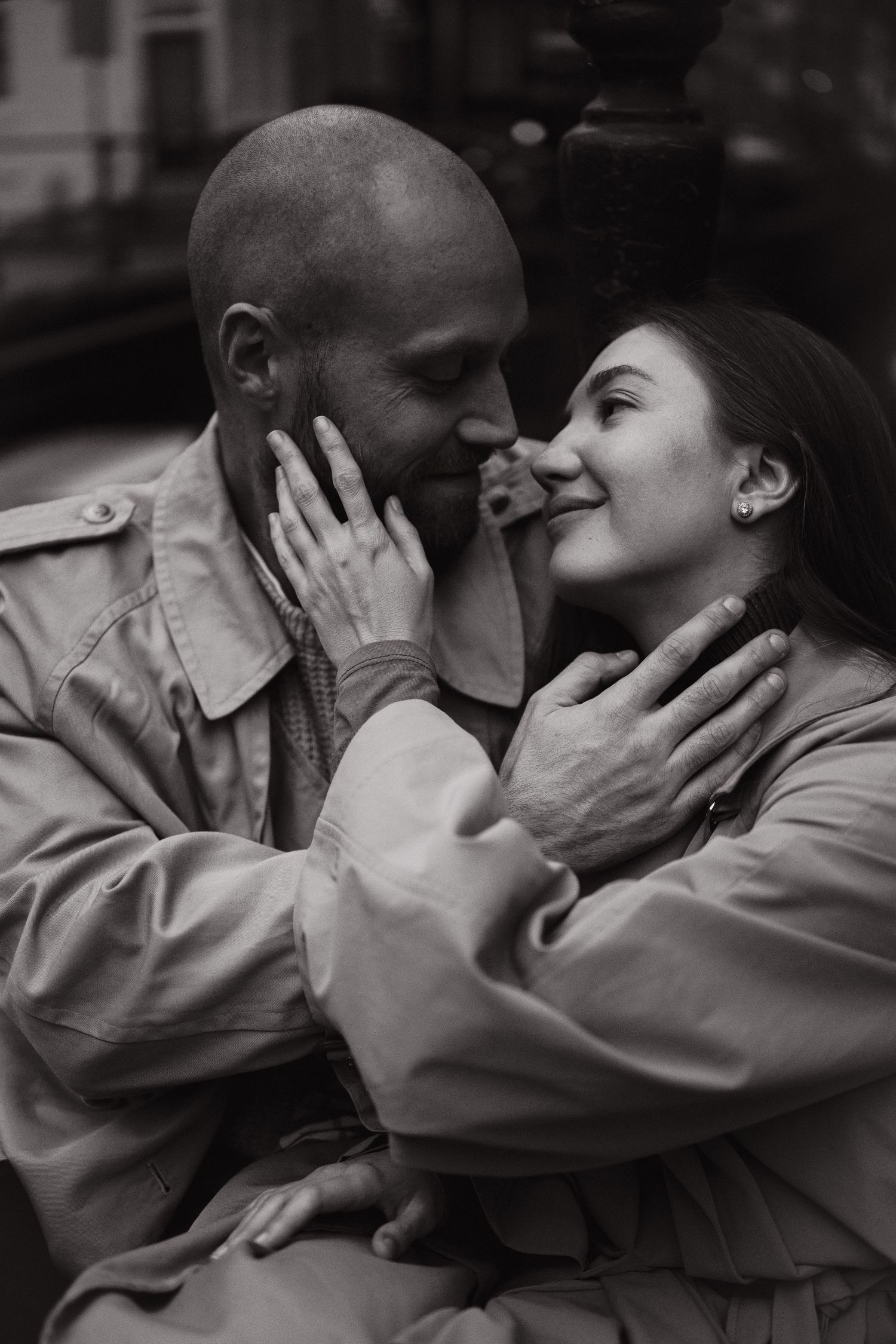 Black and white close-up of a couple smiling at each other