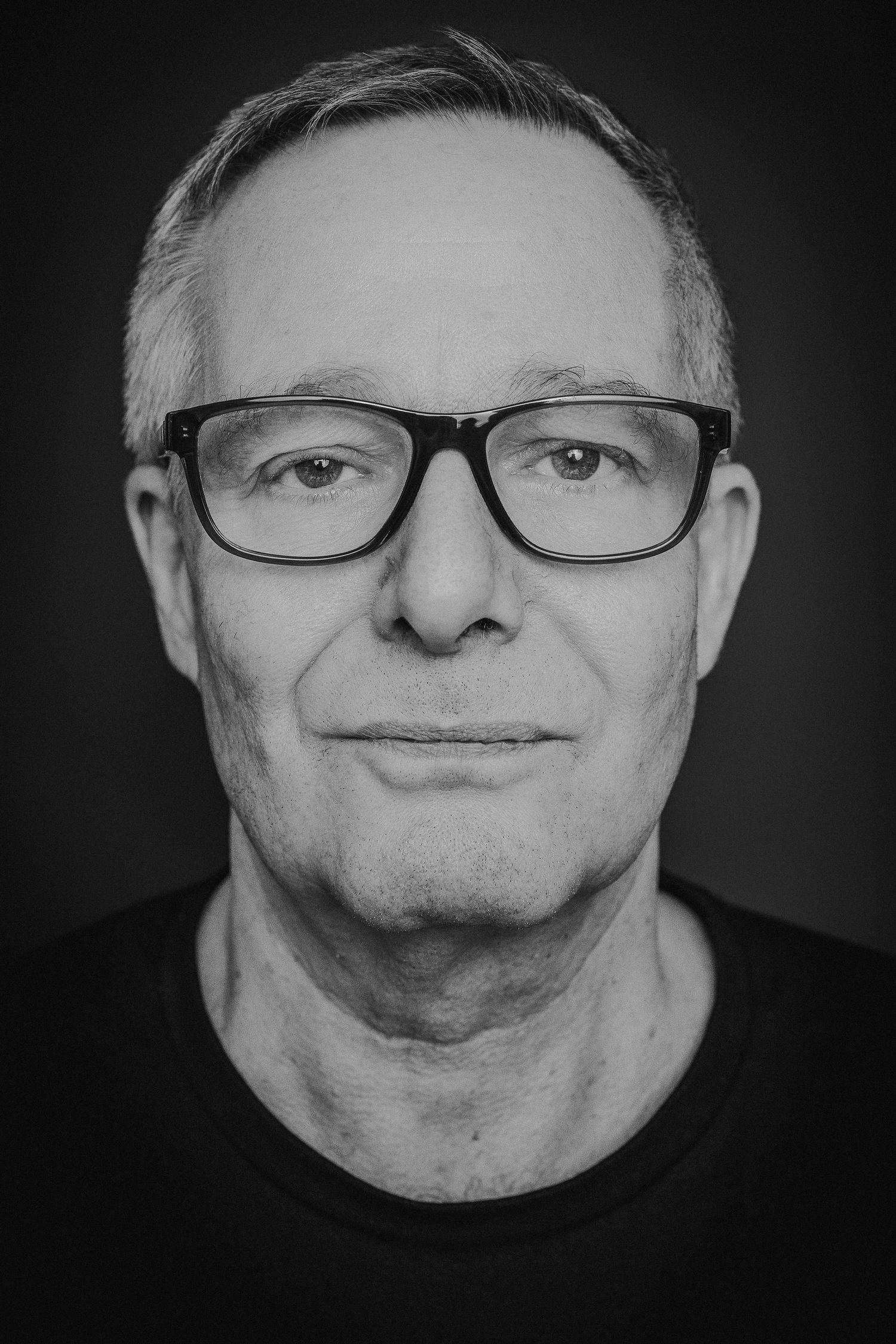 A black and white photo series showing someone making silly expressions by puffing out their cheeks and lips.