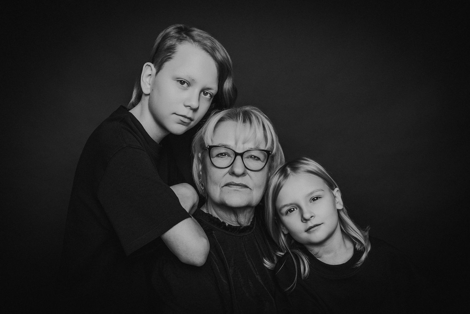 Black and white artistic portraits showing intimate emotional expressions and connections in dramatic lighting.