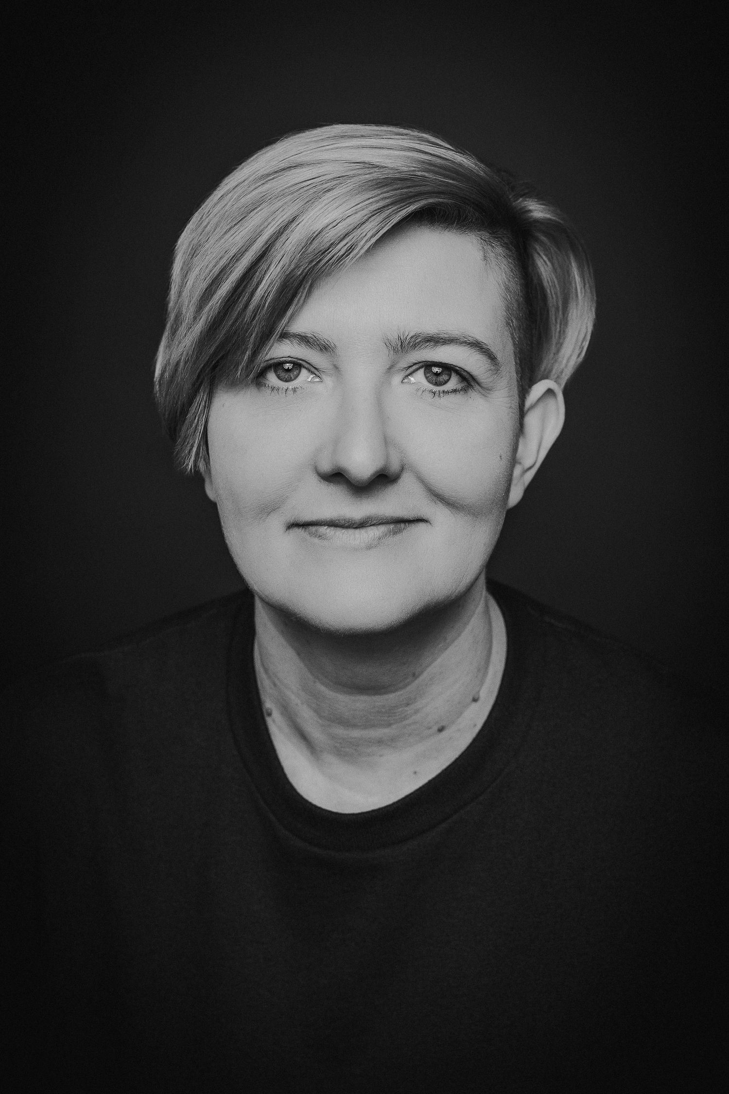 A series of black and white artistic portrait photos showing different angles and expressions in dramatic lighting.