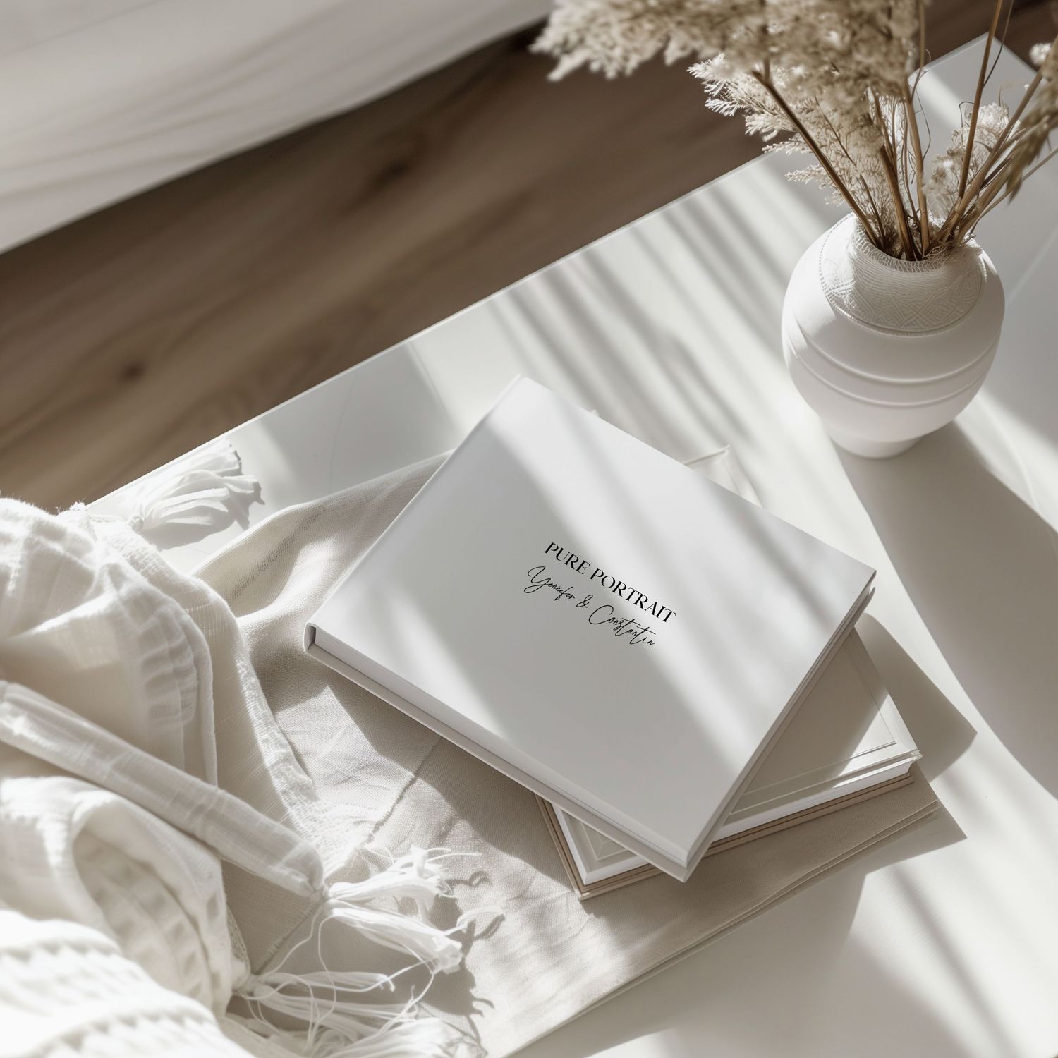 White minimalist flat lay composition with paper sheets, flowers and decorative items arranged on light surface.