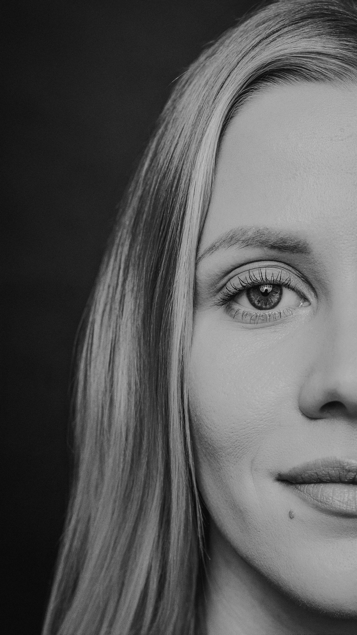 A black and white portrait sequence showing different cropped angles of a person's face and features.