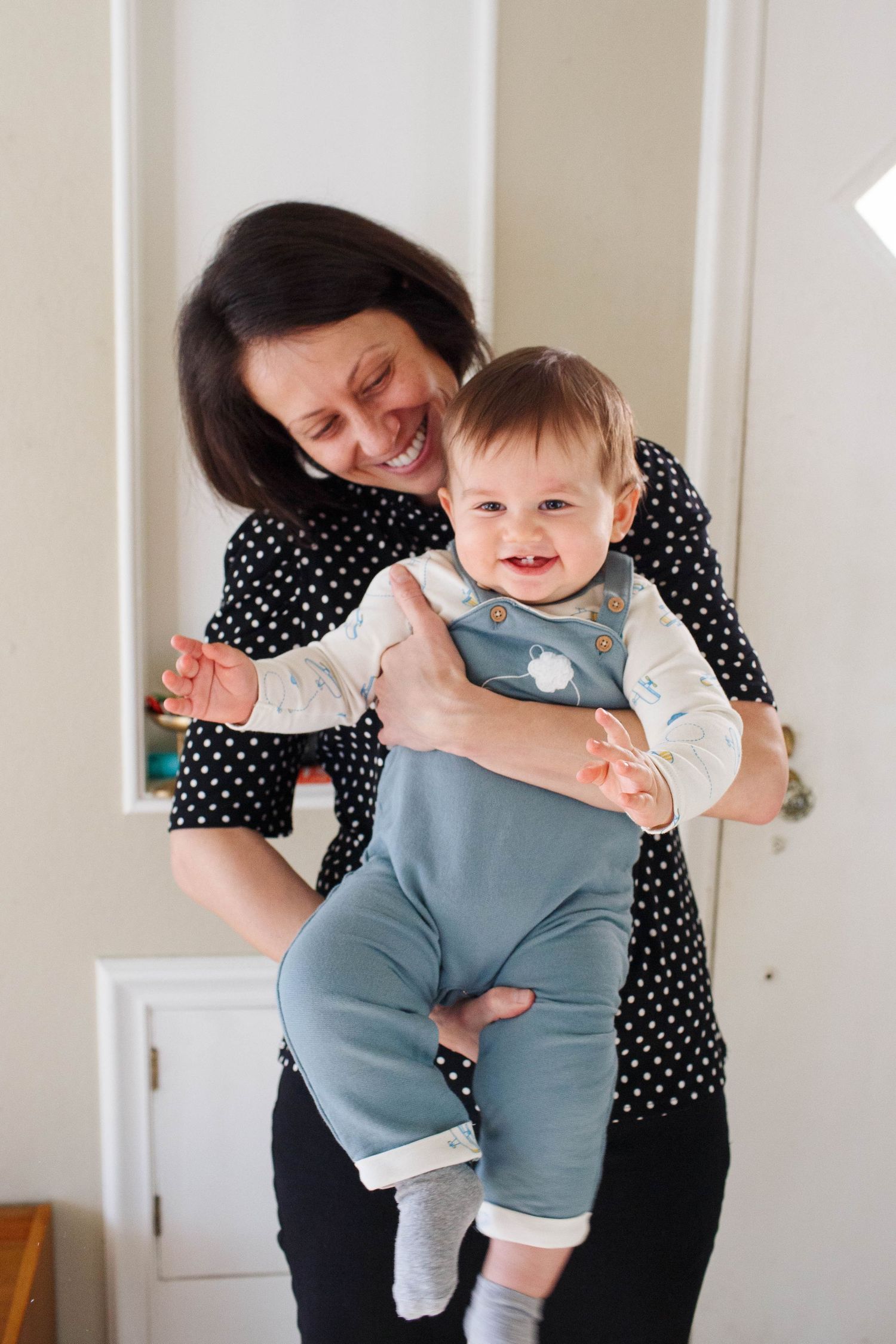 Everett family photography: a mother holds her infant son at the in-home family photo session in EVerett