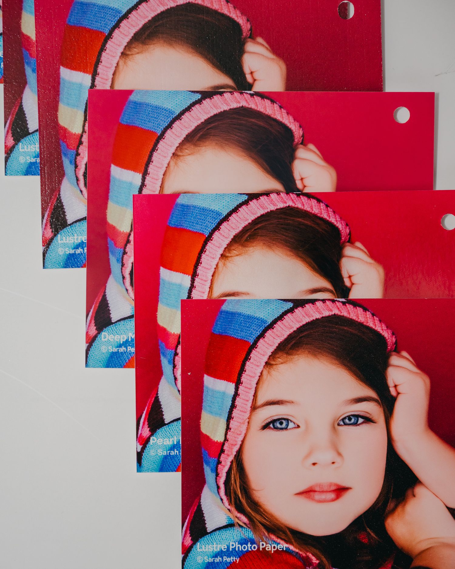 A collage of portrait photos showing a person wearing a pink baseball cap against a red and blue background.
