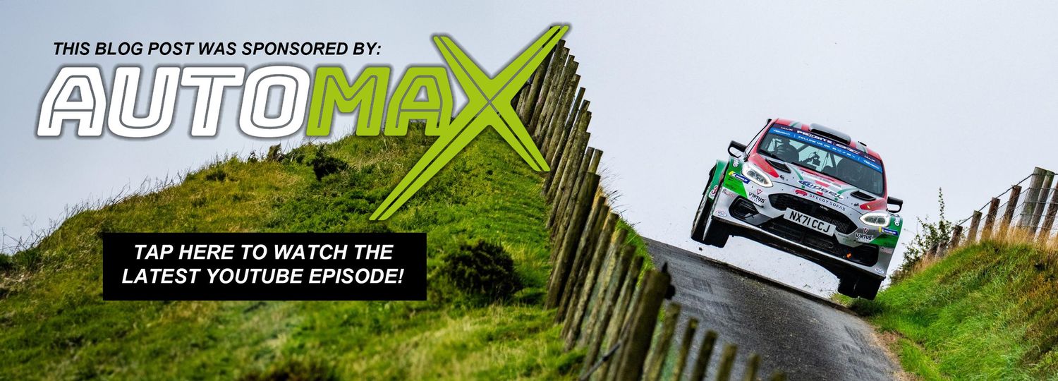 Rally car jumps over hill with AutoMax blog promotion banner overlay.