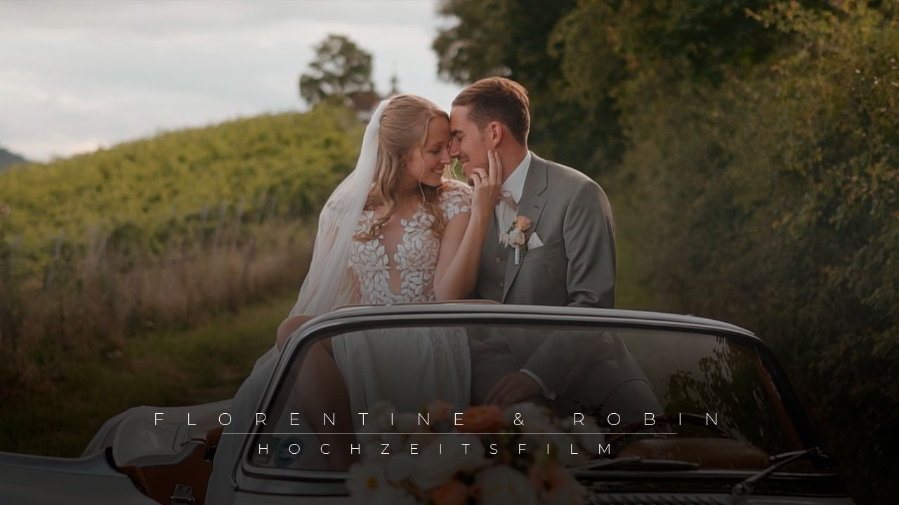 Romantic wedding couple sharing a tender moment by a vintage car in a lush countryside setting, wedding film title overlay.