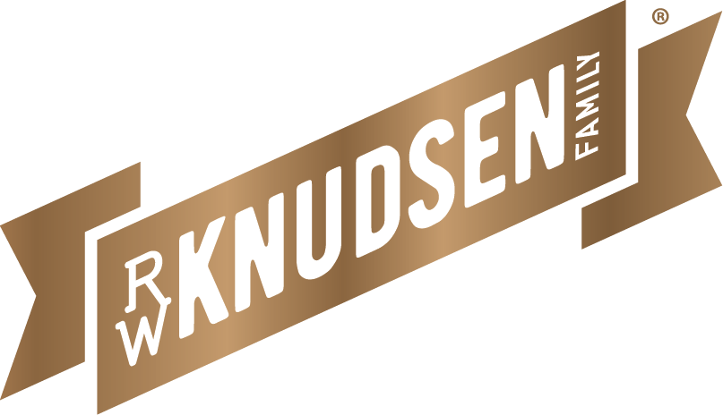 RW Knudsen Family logo on a brown banner ribbon design.