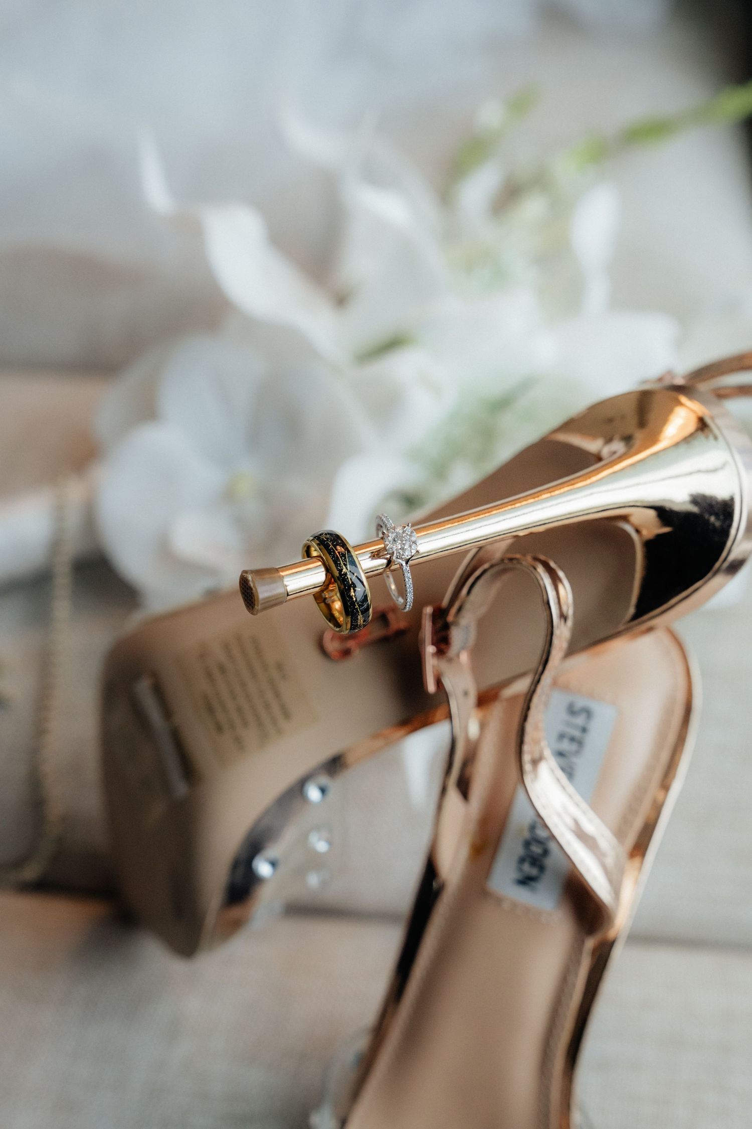 Rose gold Steve Madden wedding heels with diamond engagement ring and wedding band displayed elegantly.