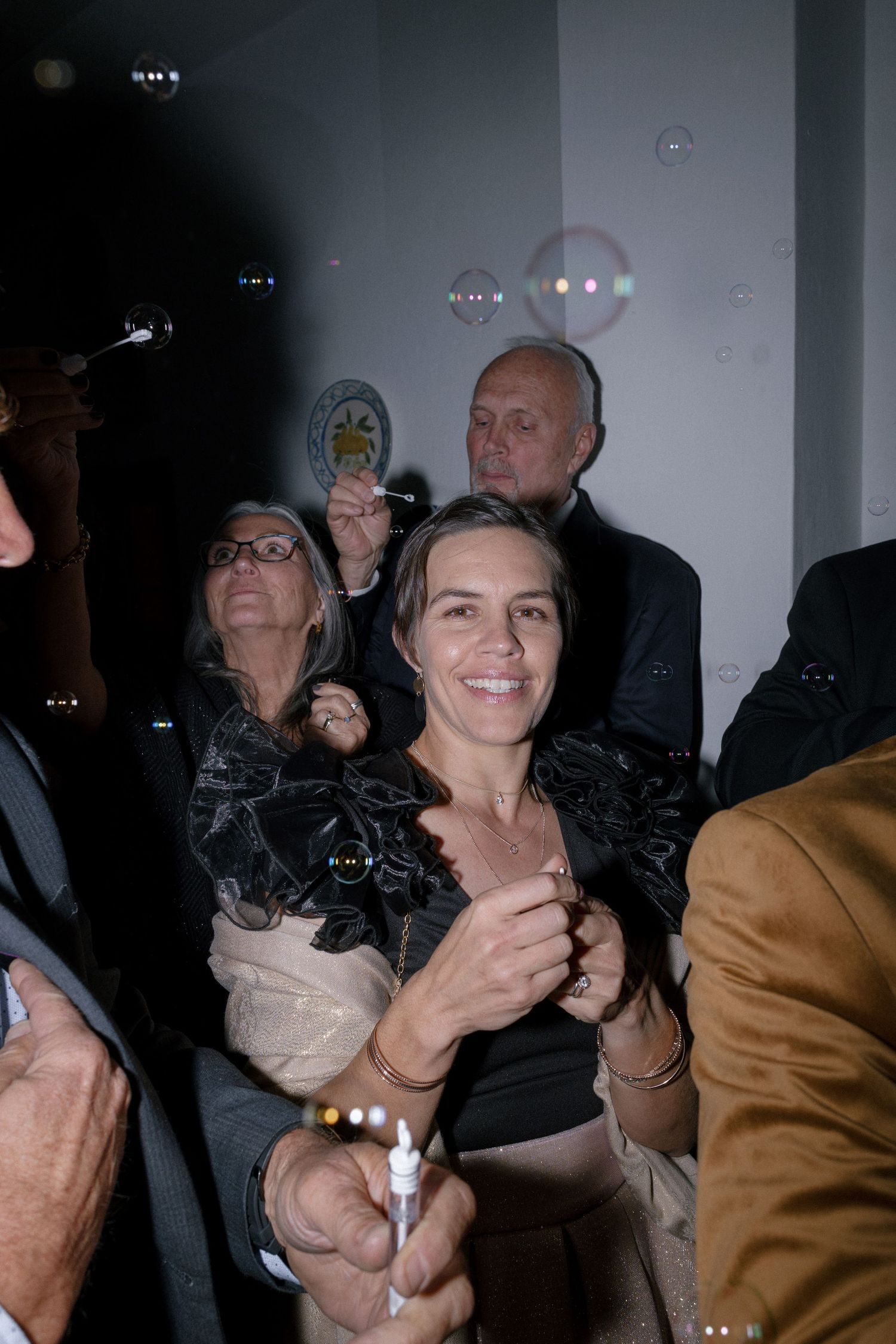 Group of adults smiling and enjoying bubbles at wedding on Cape Town