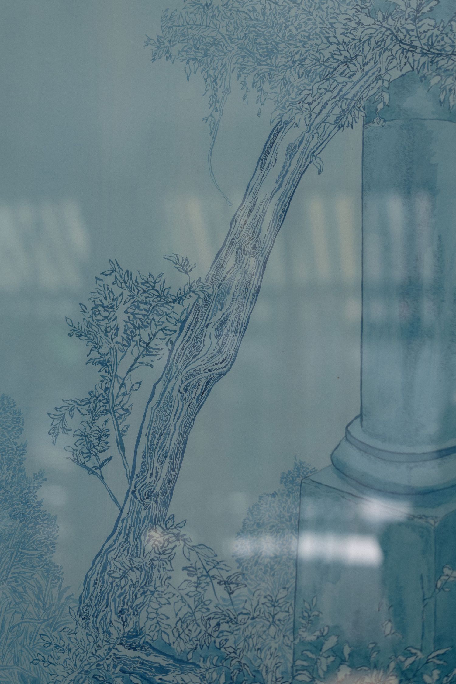 Elegant blue-toned etched glass panel featuring a classical column and tree in a romantic garden scene.