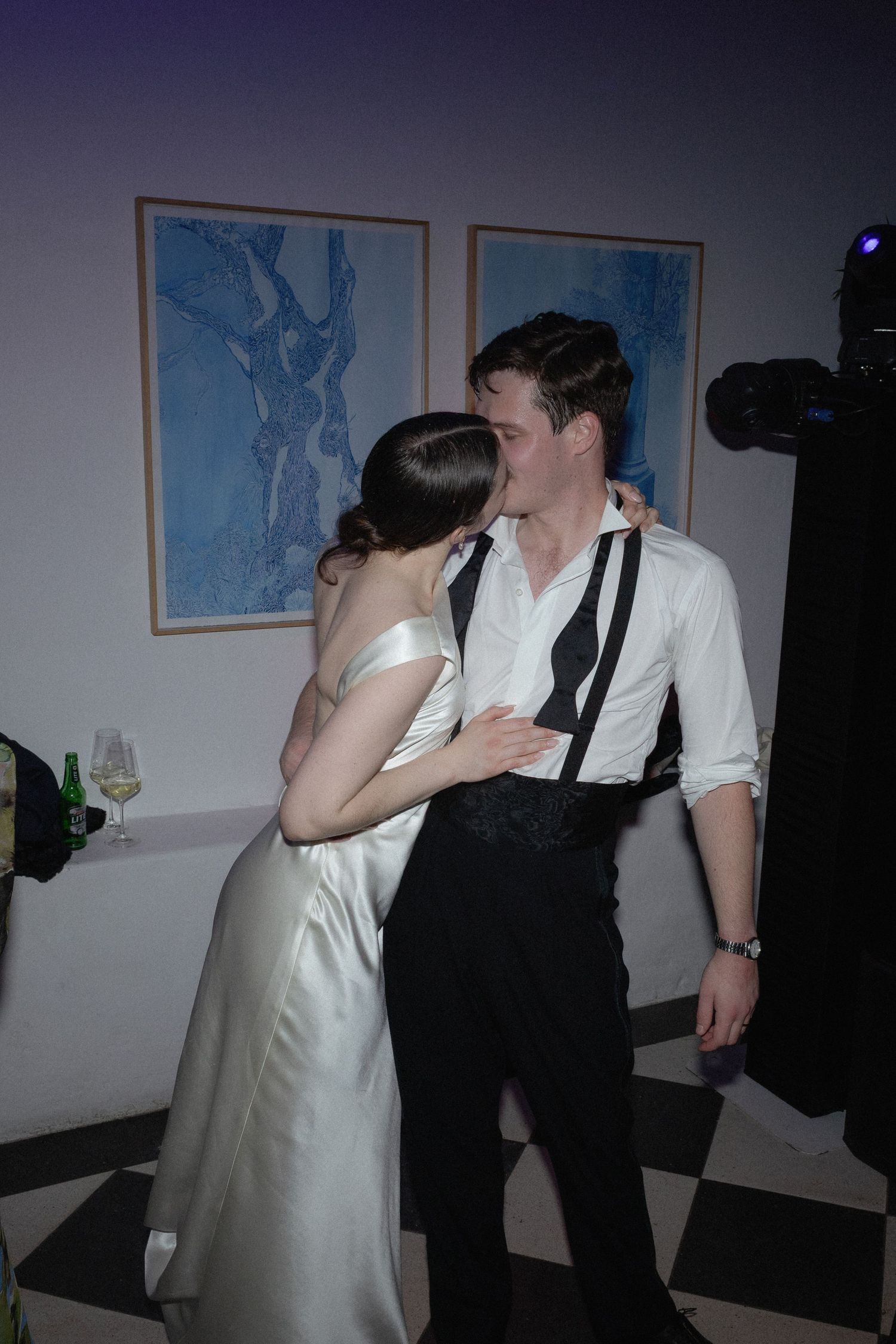 A bride and groom share a romantic kiss on the dance floor at their wedding reception.