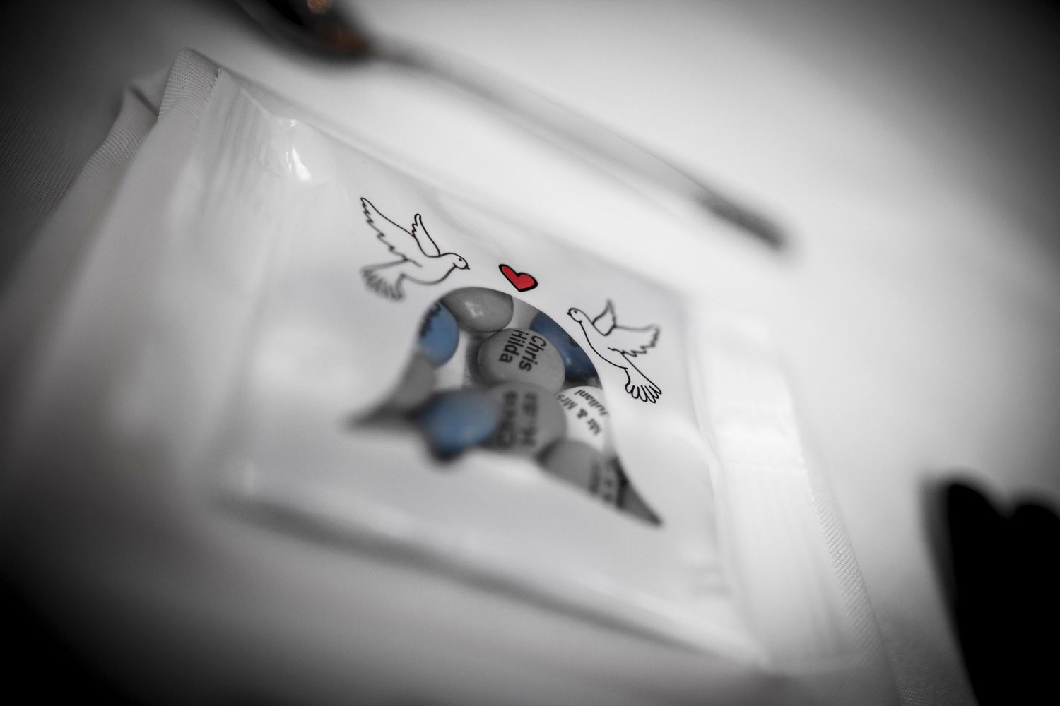 Wedding invitation with two doves and a red heart design in selective color.