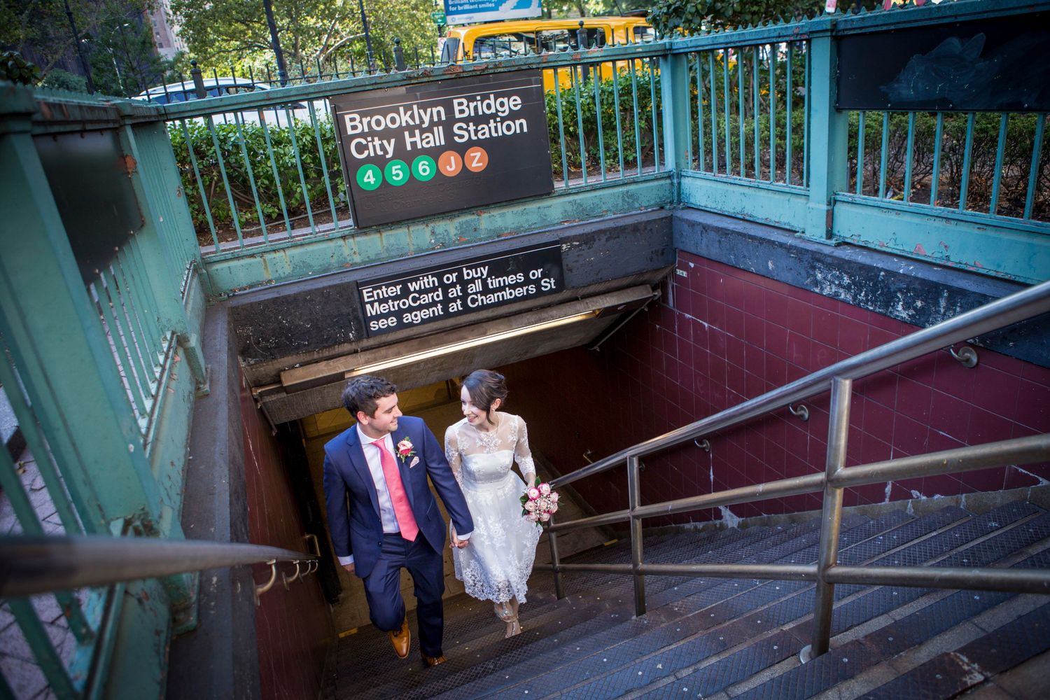Bride and groom emerging from Brooklyn Bridge City Hall subway station in New York City.