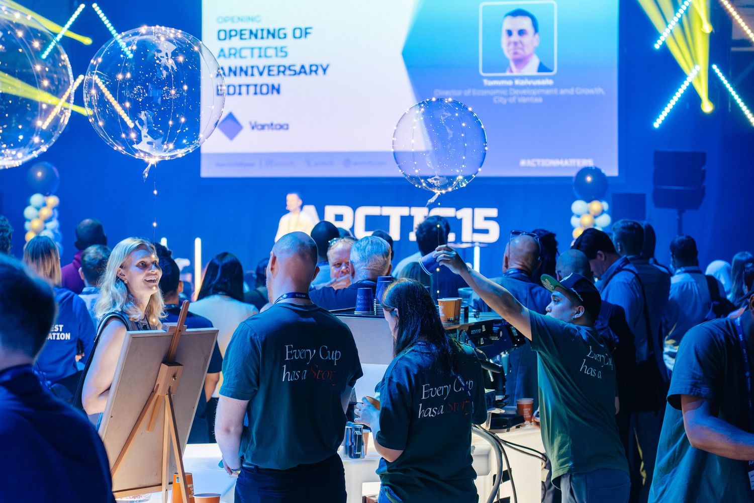 Arctic15 anniversary edition opening ceremony with audience and presenter on blue-lit stage.