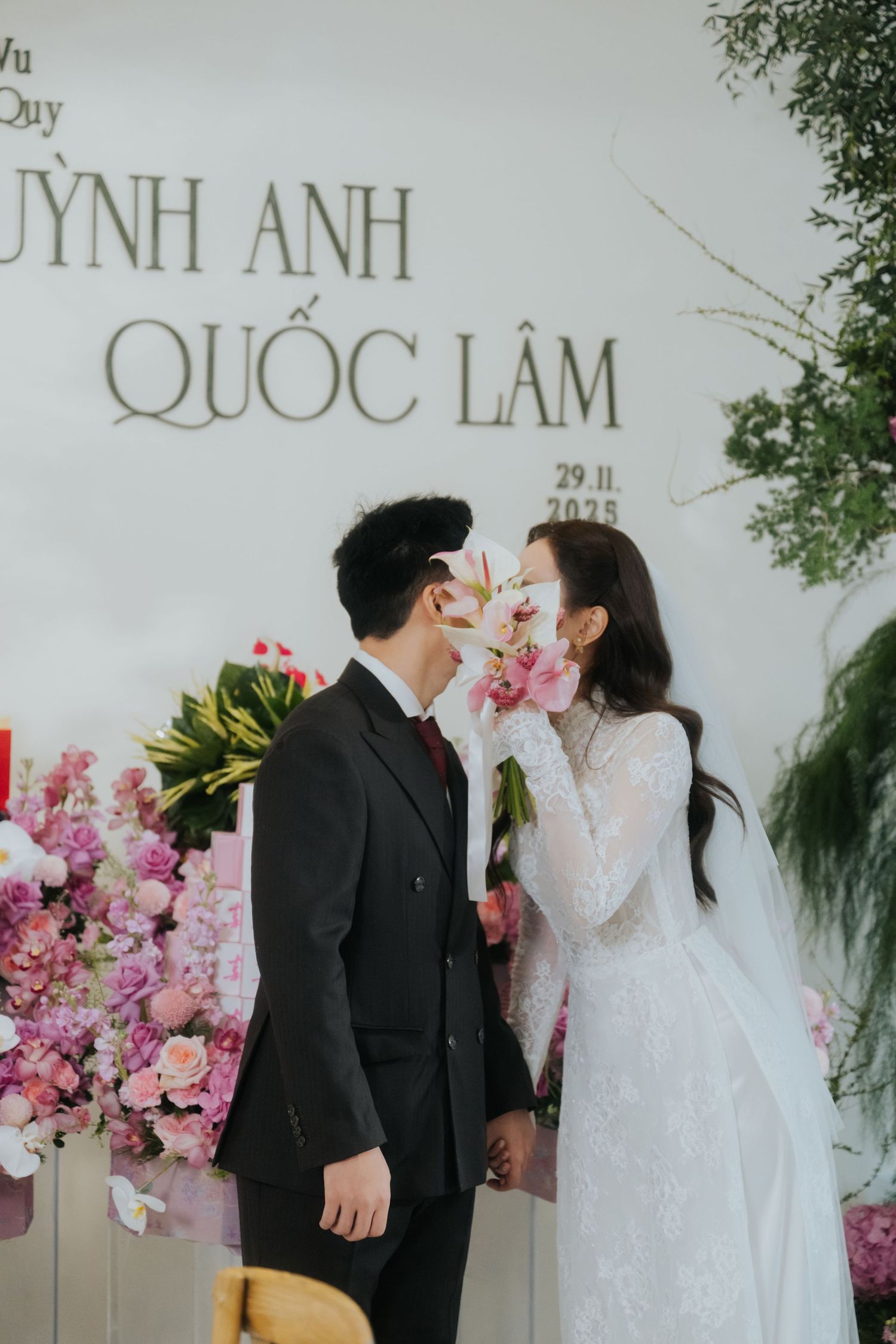 Vietnamese couple Quynh Anh and Quoc Lam share a romantic moment at their wedding ceremony on November 29, 2025.
