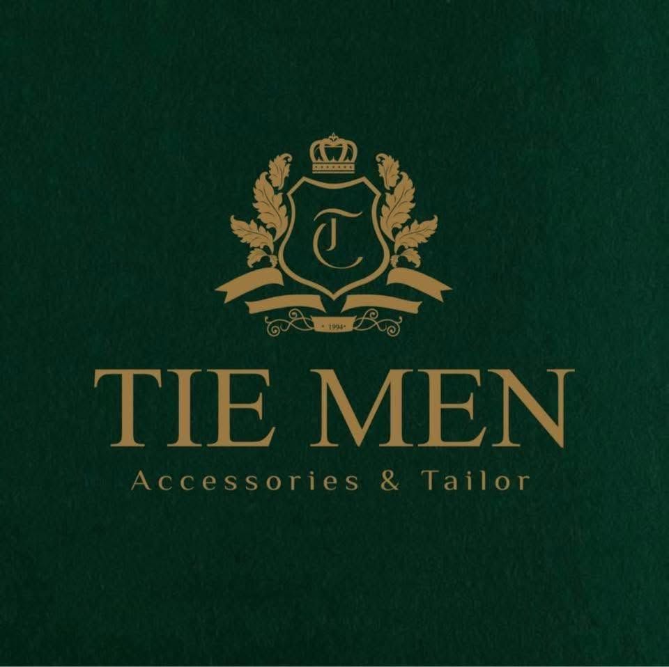 Tie Men Accessories & Tailor logo featuring a gold heraldic crest with crown on a dark green background.