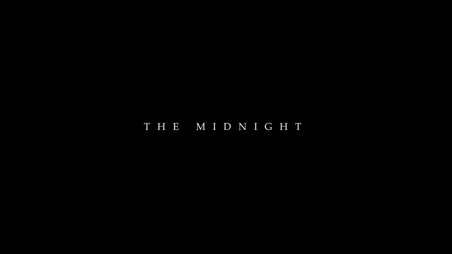 The Midnight band logo displayed in elegant white serif text on a minimalist black background.