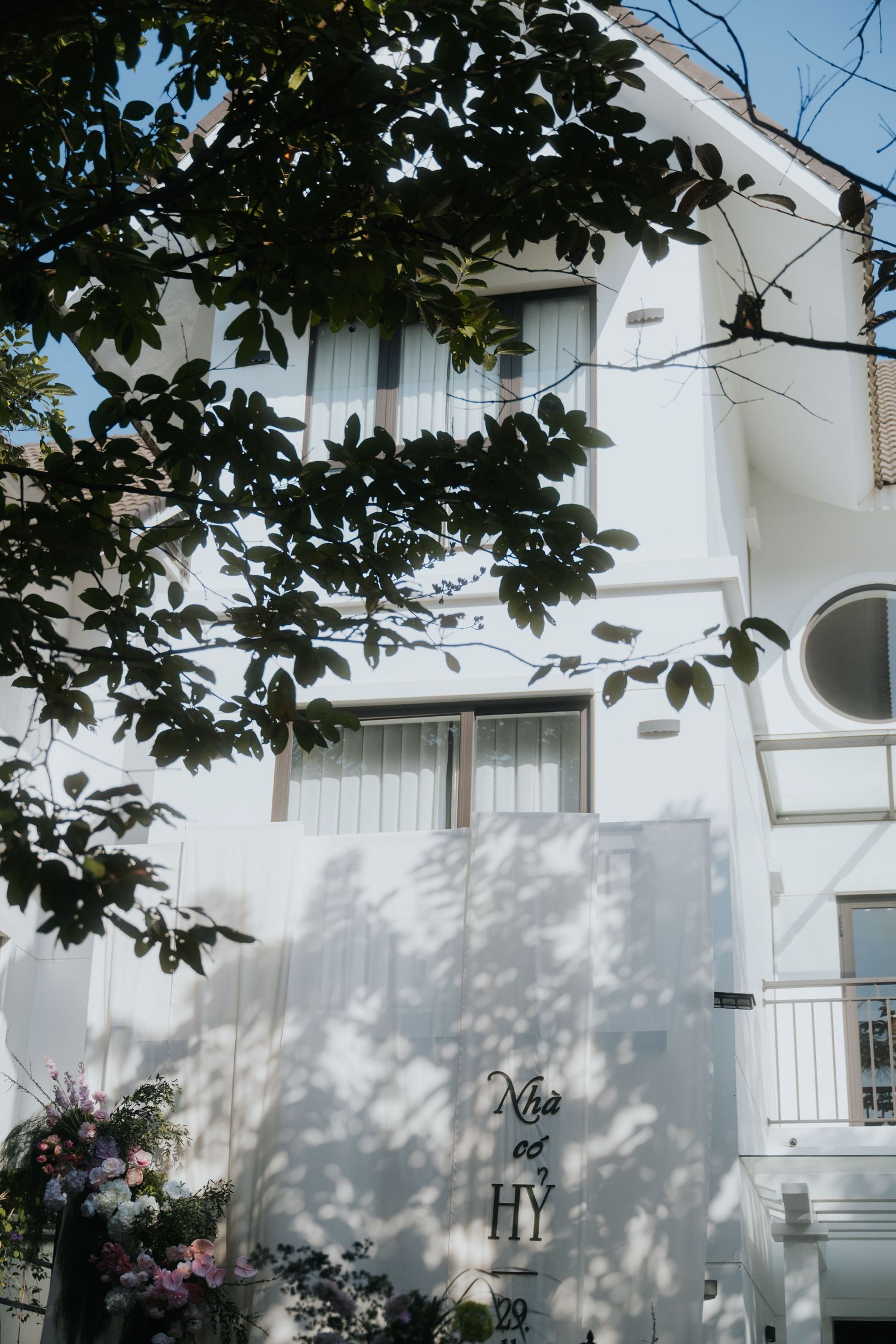 White two-story Vietnamese building with 