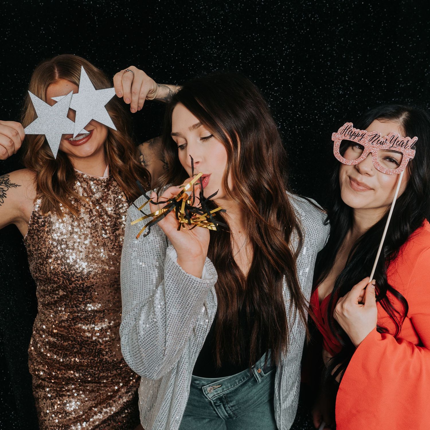 Group photo session with sparkly outfits and paper star props. Fremont, Ohio Hair Salon