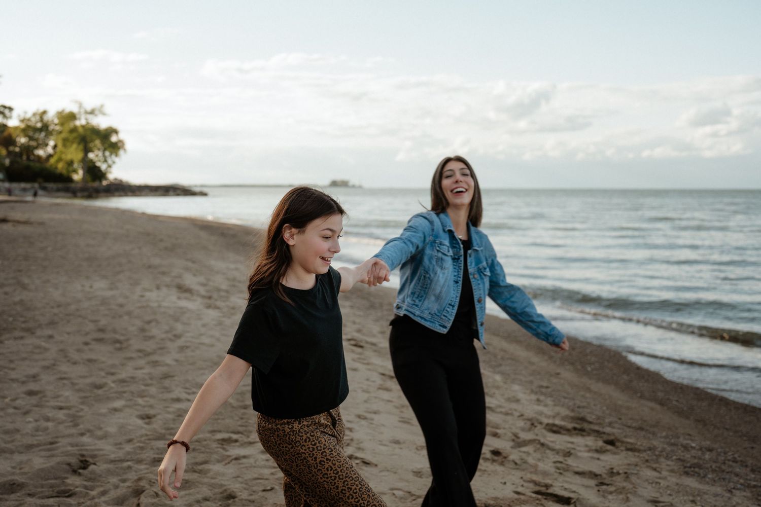 Candid moment captured on sandy beach at sunset. Huron Ohio Beach