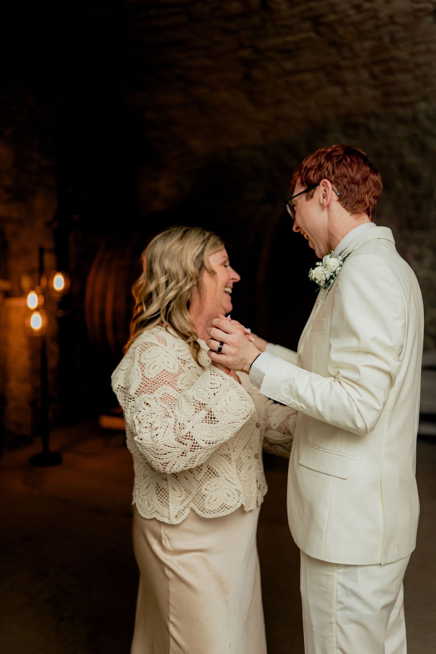 A couple shares an intimate dance moment in a candlelit stone room. Gideon Owen Winery ohio wine cellar