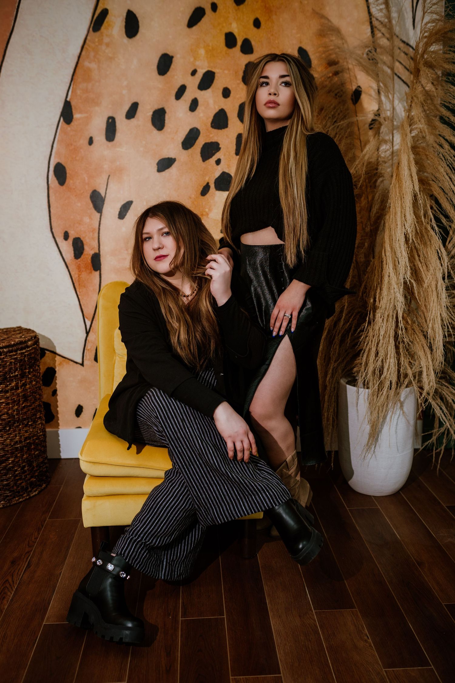 Fashion photos against a spotted wall with dried pampas grass decor and yellow furniture. Fremont, Ohio Hair Salon