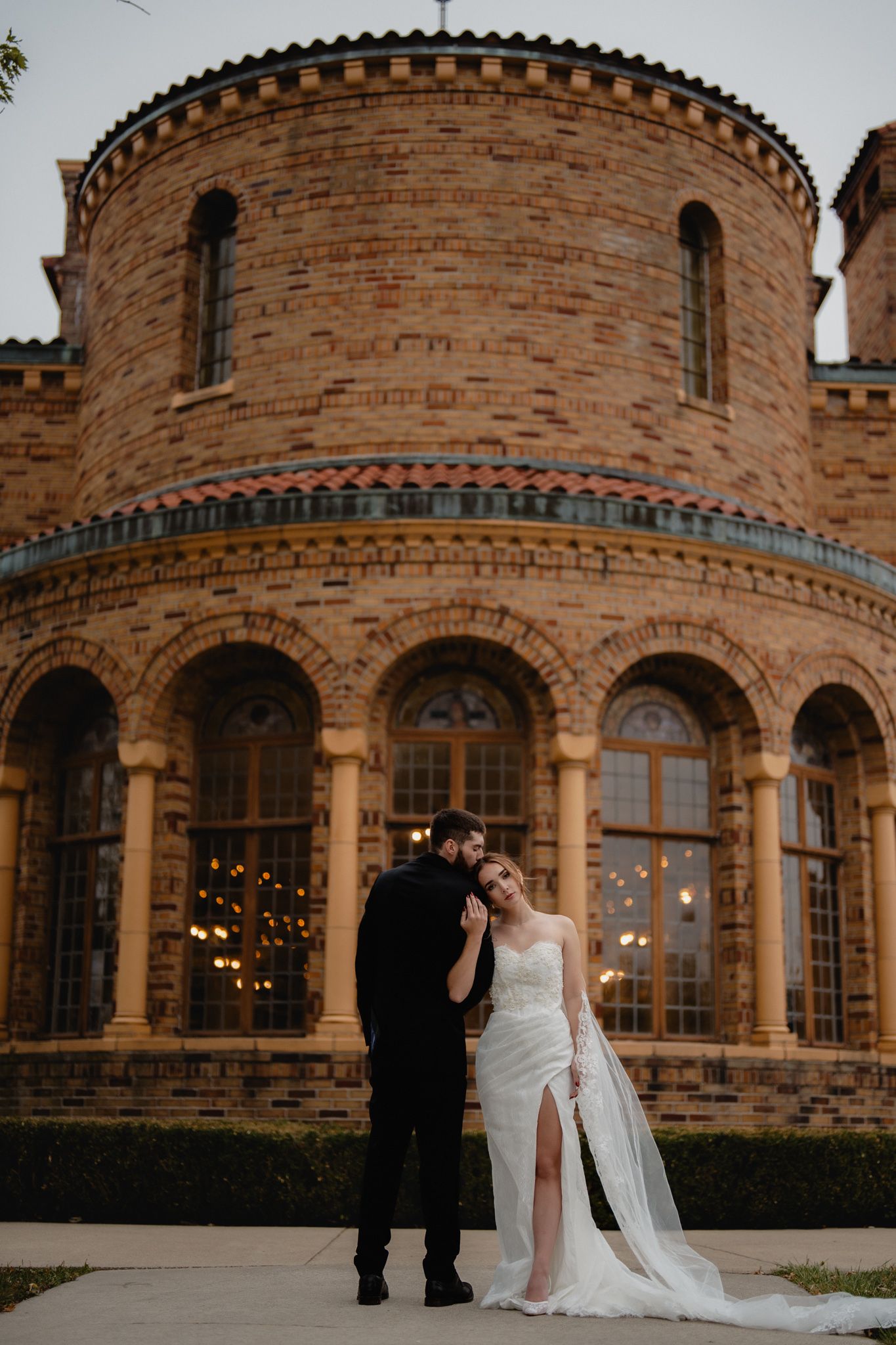 Elegant stone castle-like wedding venue with arched windows and romantic lighting at dusk. Nazareth hall, grand rapids, OHIO