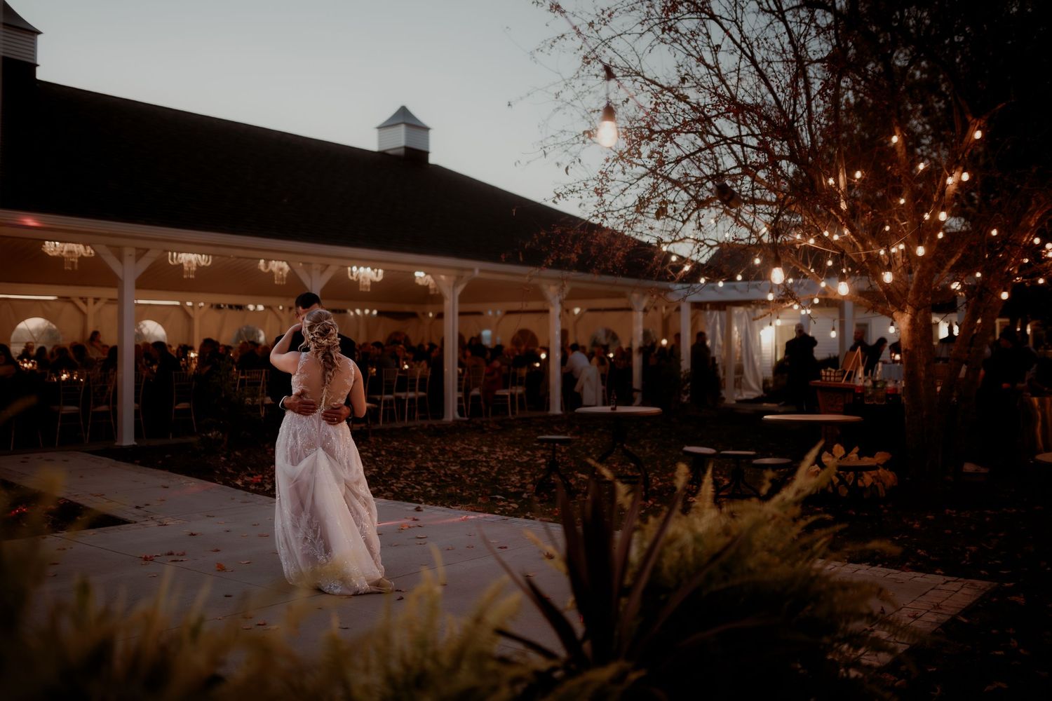 Wedding venue exterior with string lights and gazebo illuminated at dusk. Sandusky Ohio Wedding Venue