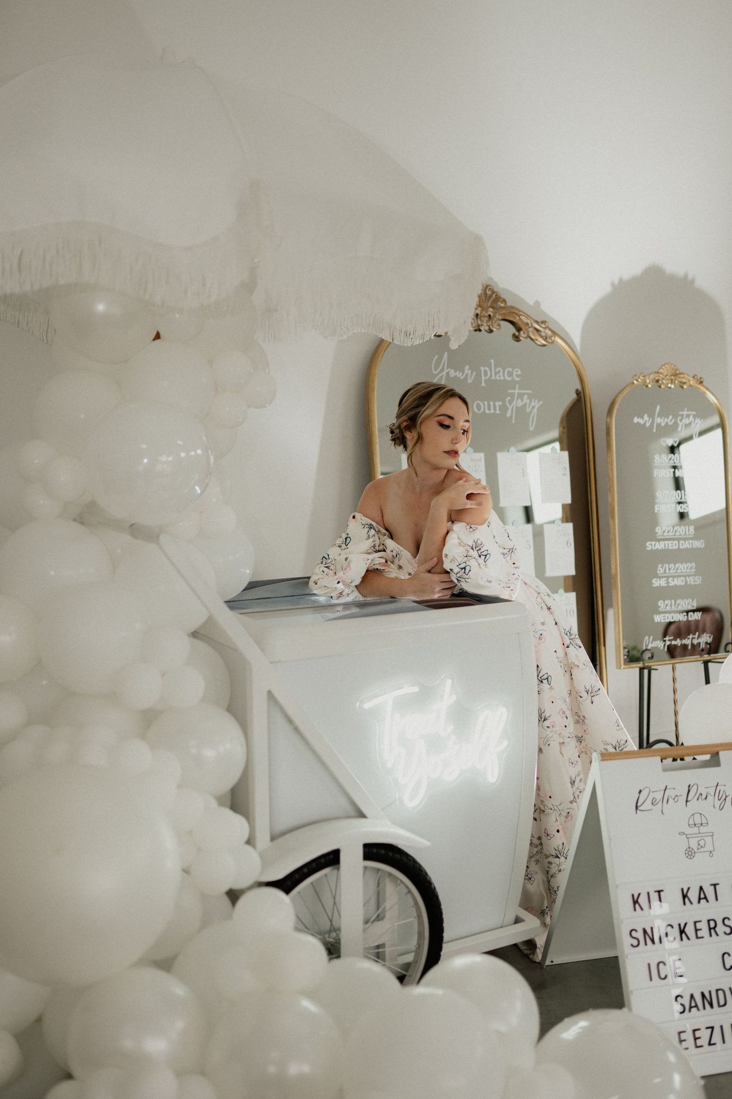 Elegant wedding decor featuring white balloons and signage in a light-filled room. Wooster Ohio The Wellspring Wedding Venue