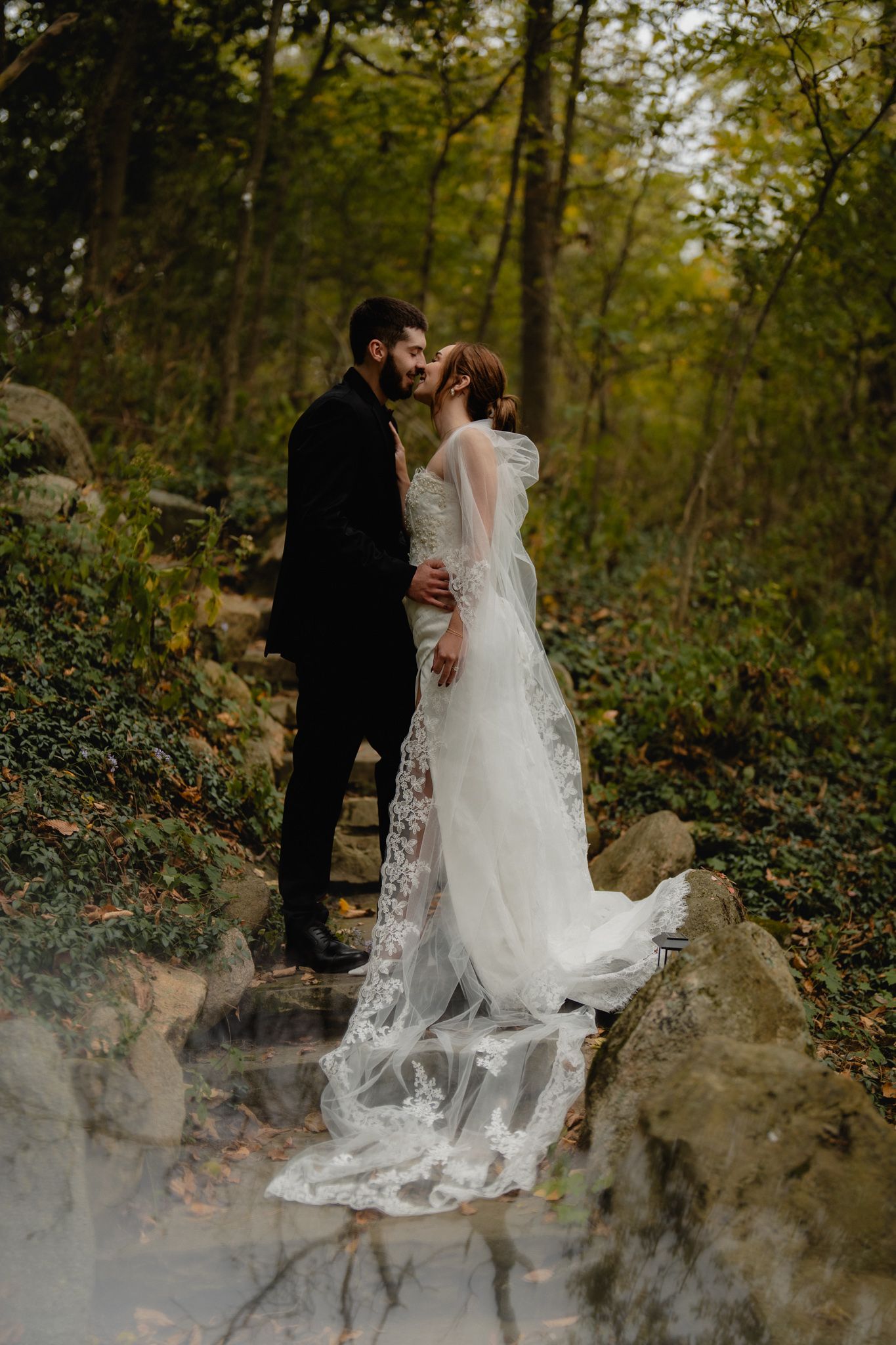 Romantic wedding portrait on stone path surrounded by lush greenery and fog. Nazareth hall, grand rapids, OHIO