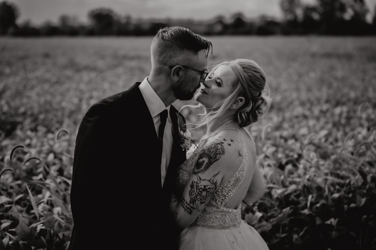 An intimate black and white portrait in a field at golden hour. Tiffin, Ohio Wedding Venue