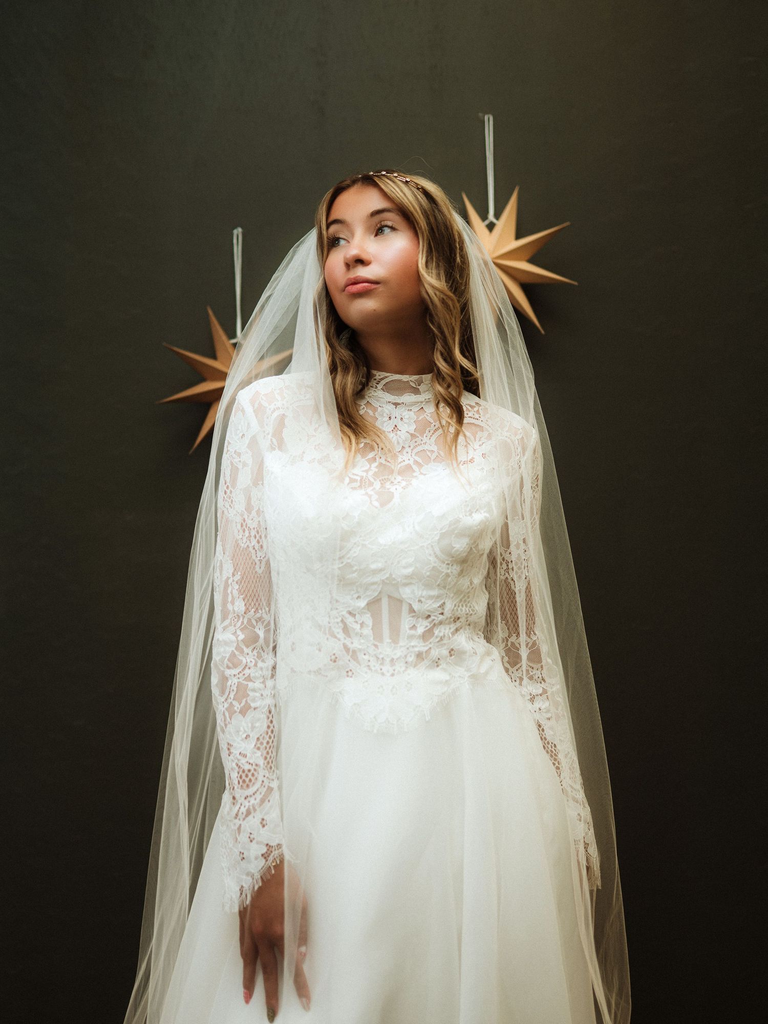 Ethereal bridal portrait with flowing veil against dark background. Clyde, Ohio
