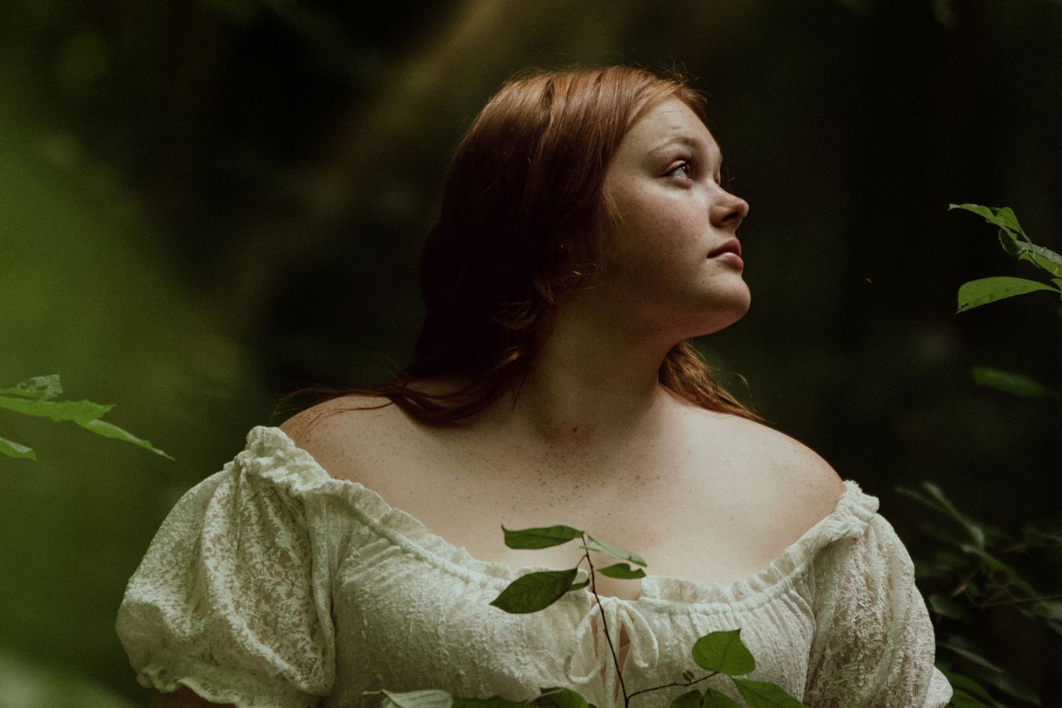 Dreamy portrait series in vintage dress with soft natural lighting and dark foliage background. Clyde, Ohio
