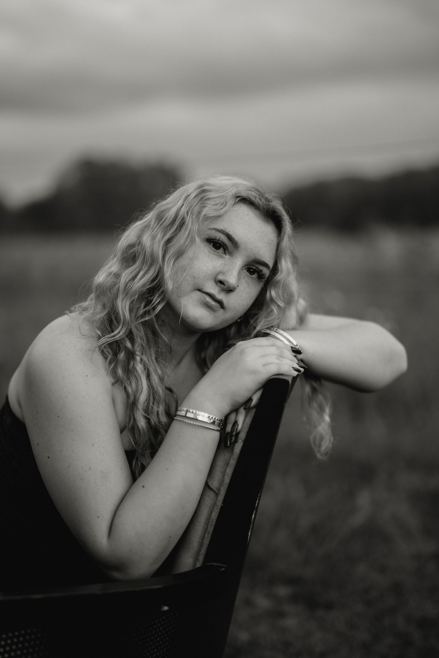 Artistic black and white portrait series showing contemplative poses against a blurred outdoor background. Steyer Nature Preserve Tiffin, Oh