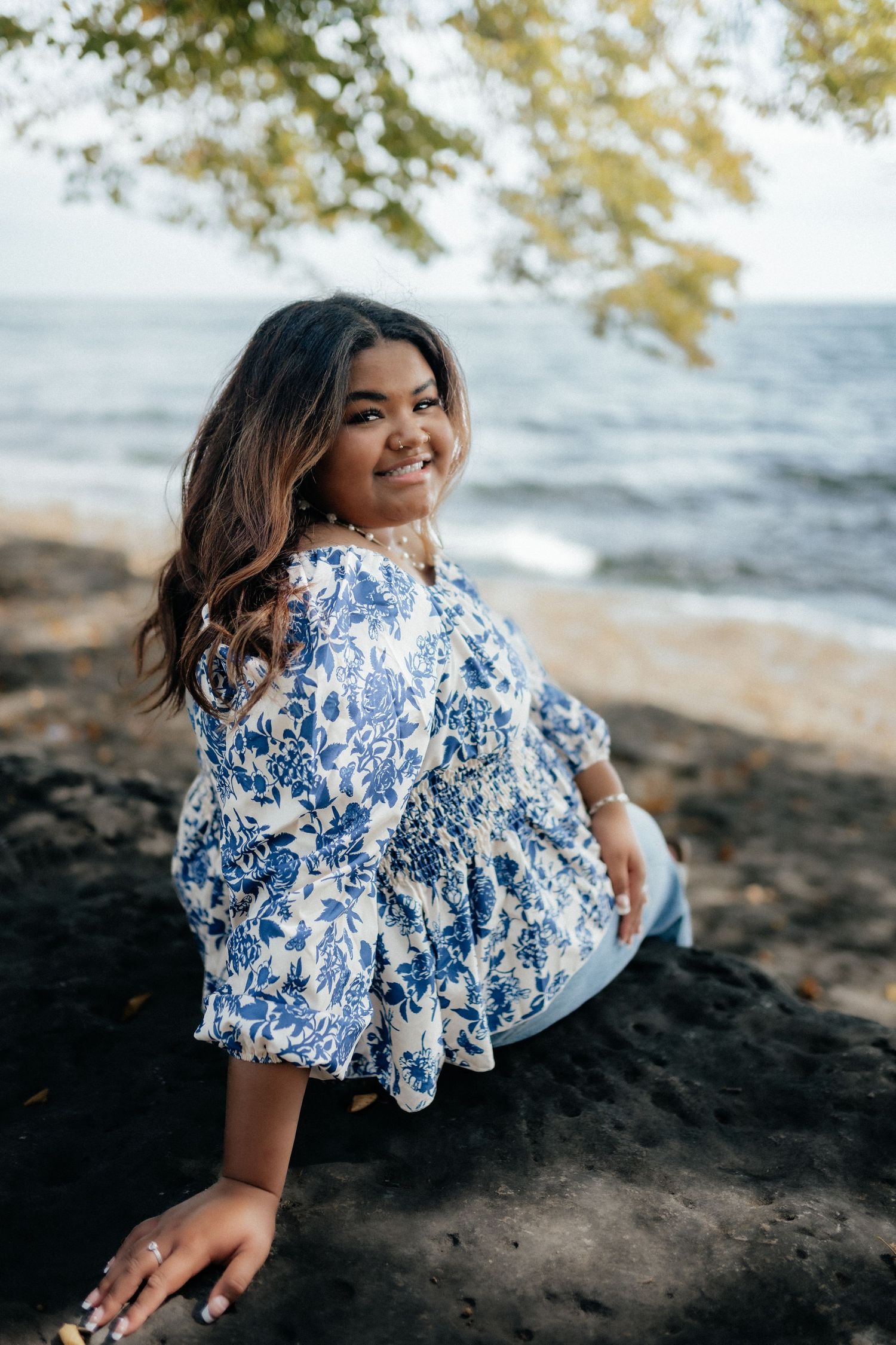 Joyful portrait in blue and white patterned dress by the beach. Marblehead Lighthouse Ohio