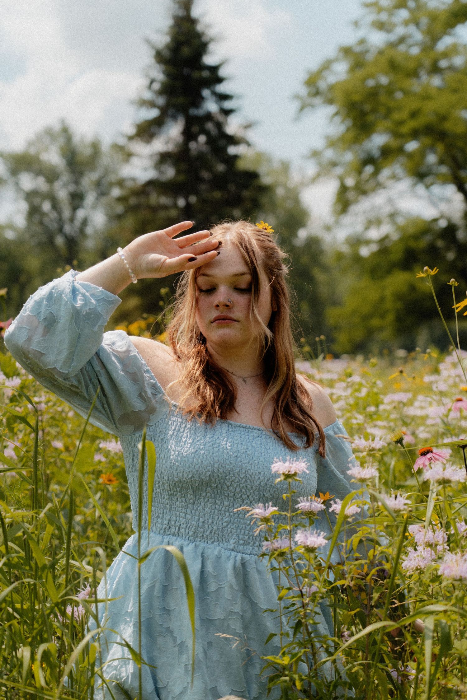 Dancing movements captured in a flowery field wearing a light blue summer dress. fremont, ohio