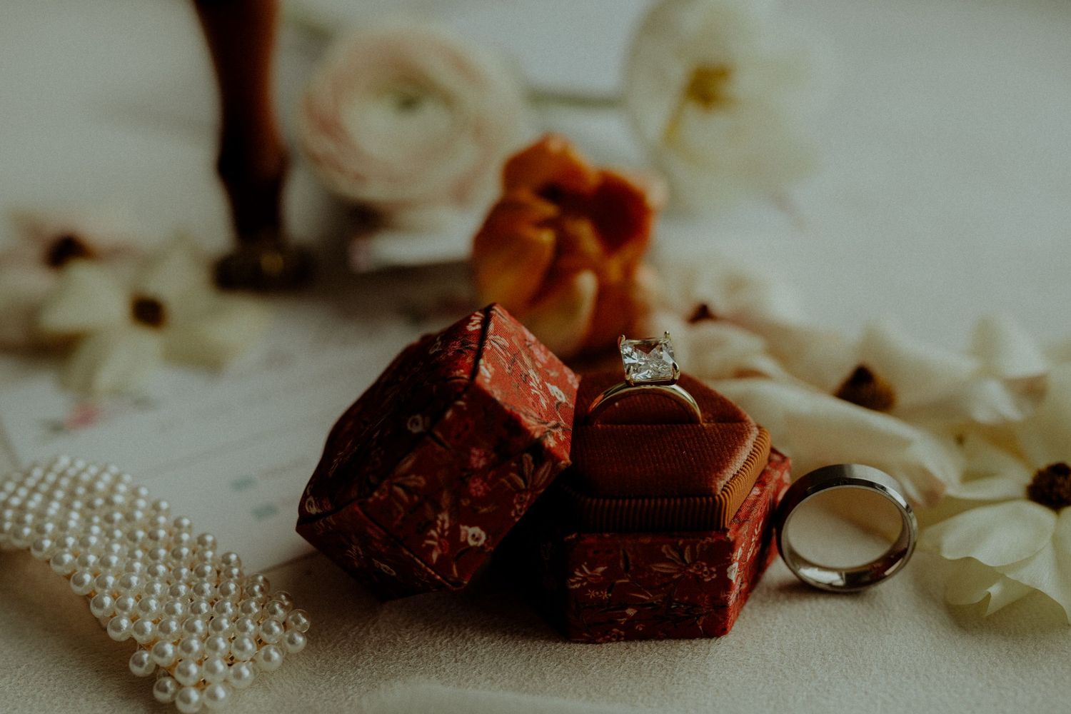 Still life composition with chocolate pieces, pearls, and jewelry details. Wooster Ohio The Wellspring Wedding Venue