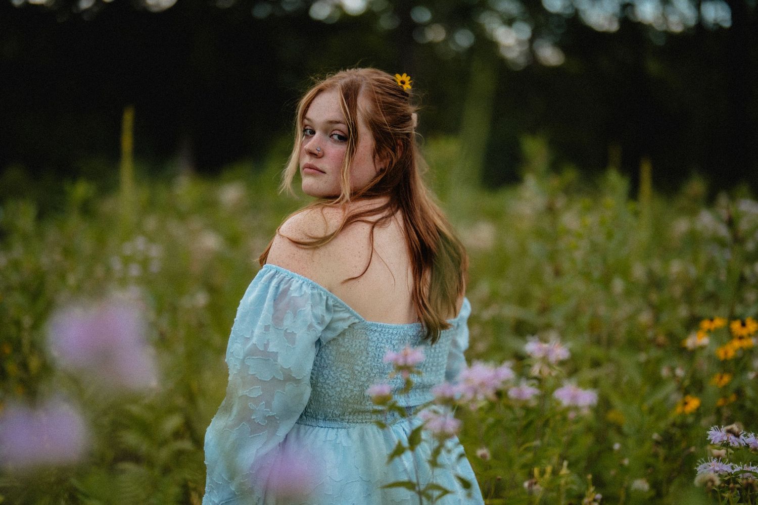 Romantic portrait series in a wildflower meadow wearing flowing blue dress. fremont, ohio