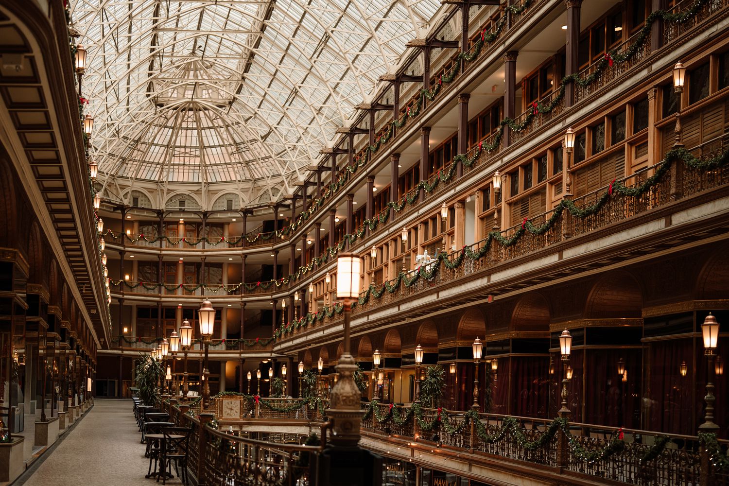 Interior view of a grand Victorian arcade with glass ceiling and vintage lighting. The arcade, Cleveland OHIO